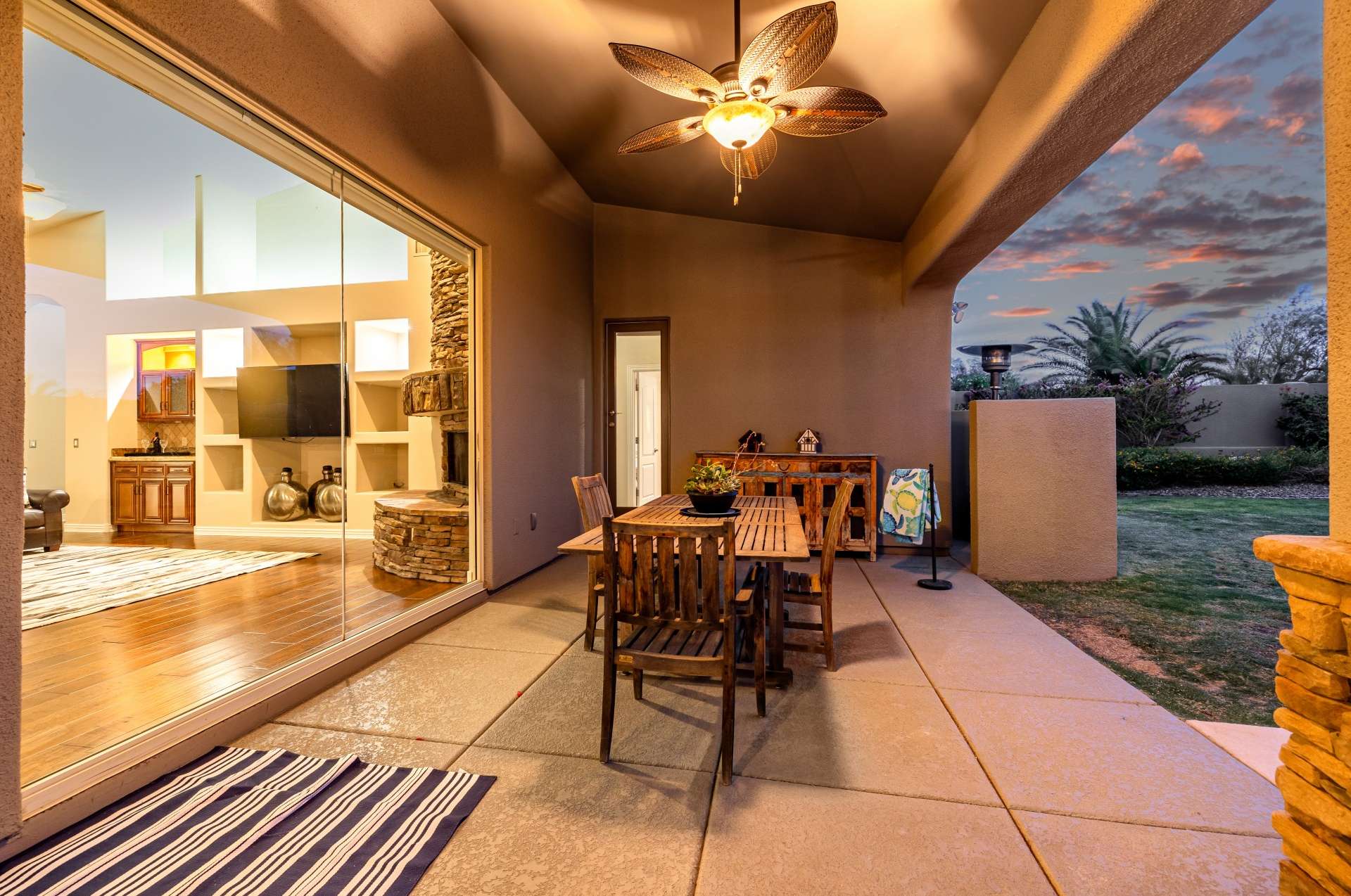 34 of 65. The glow of sunset illuminates this covered space, creating a cozy ambiance perfect for intimate dinners or relaxed evening lounging. The design highlights energy-conscious features and effortless flow.