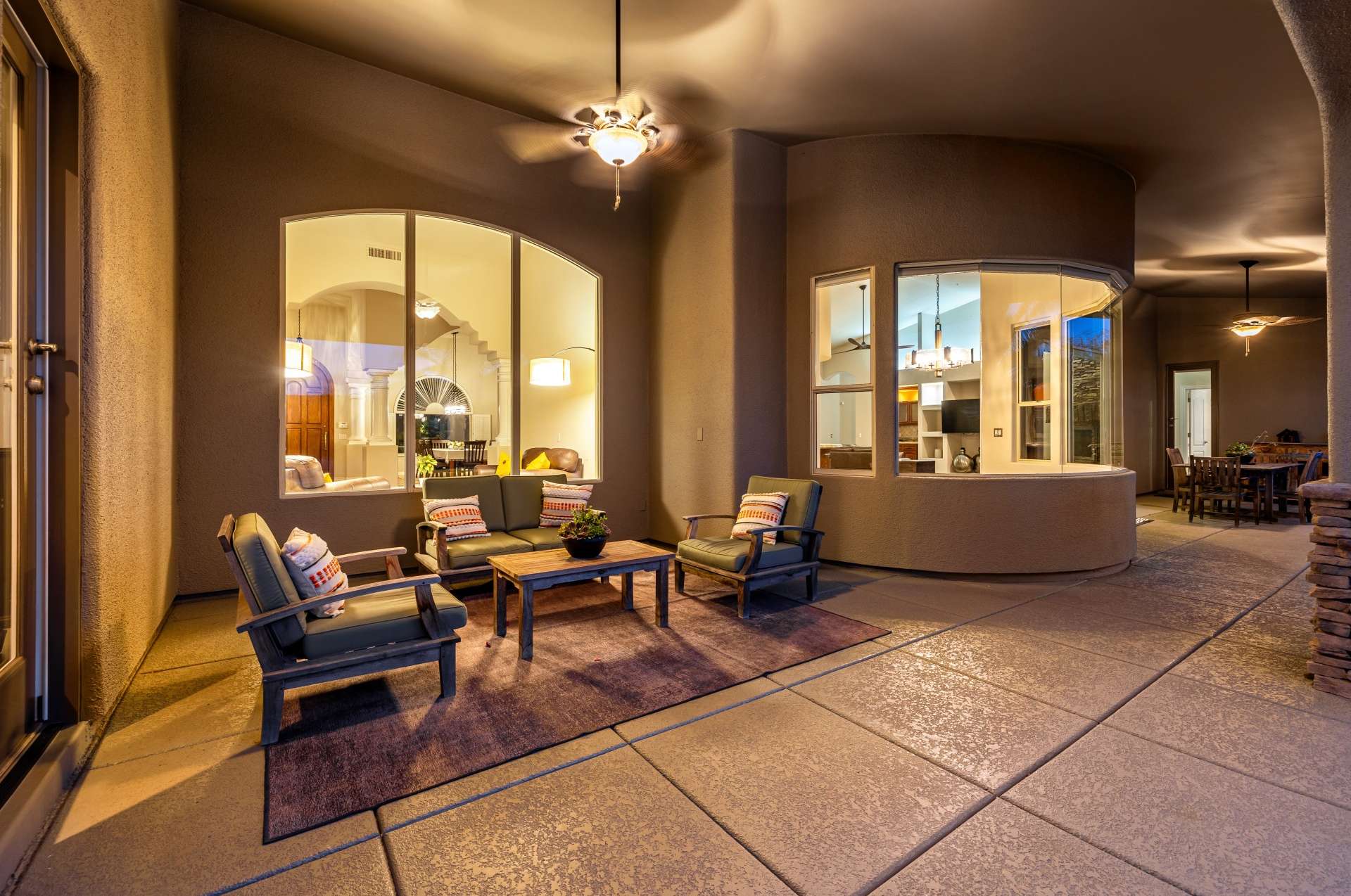 37 of 65. As evening falls, this peaceful outdoor lounge glows with warmth and charm. The ideal backdrop for unwinding after a long day, this covered space balances privacy with inviting ambiance.