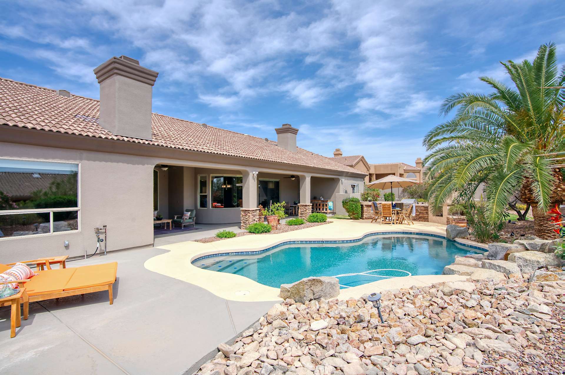 39 of 65. Surrounded by tropical landscaping, this resort-style backyard offers a shimmering pool with waterfall accents and vibrant foliage. A true entertainer s dream nestled in a scenic Arizona setting.