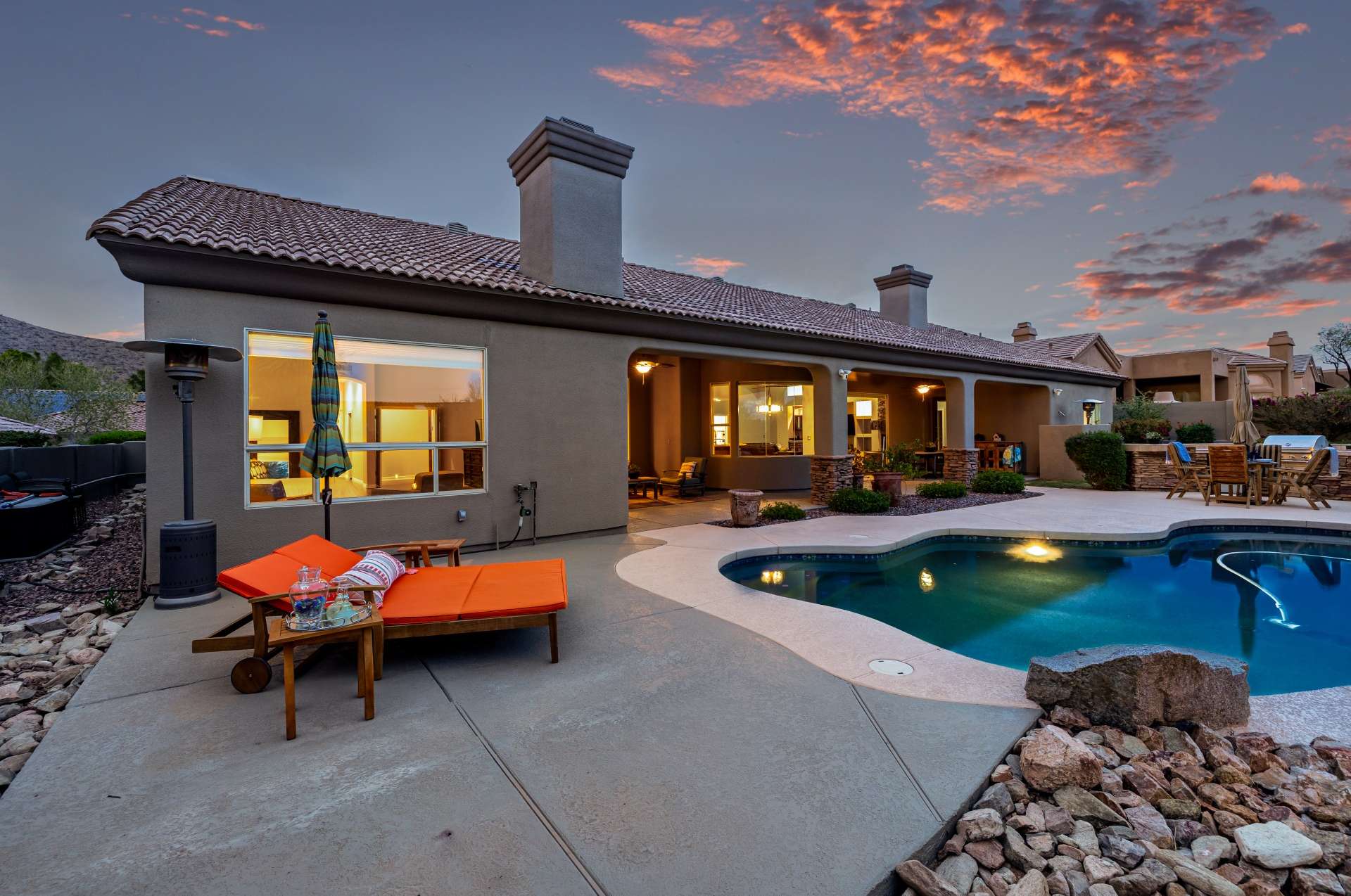 40 of 65. Take in the soft Arizona sunset from this spacious poolside lounge, complete with built-in landscaping and updated hardscaping. The sparkling pool reflects the warmth of golden hour while the expansive patio invites relaxation and alfresco entertaining.