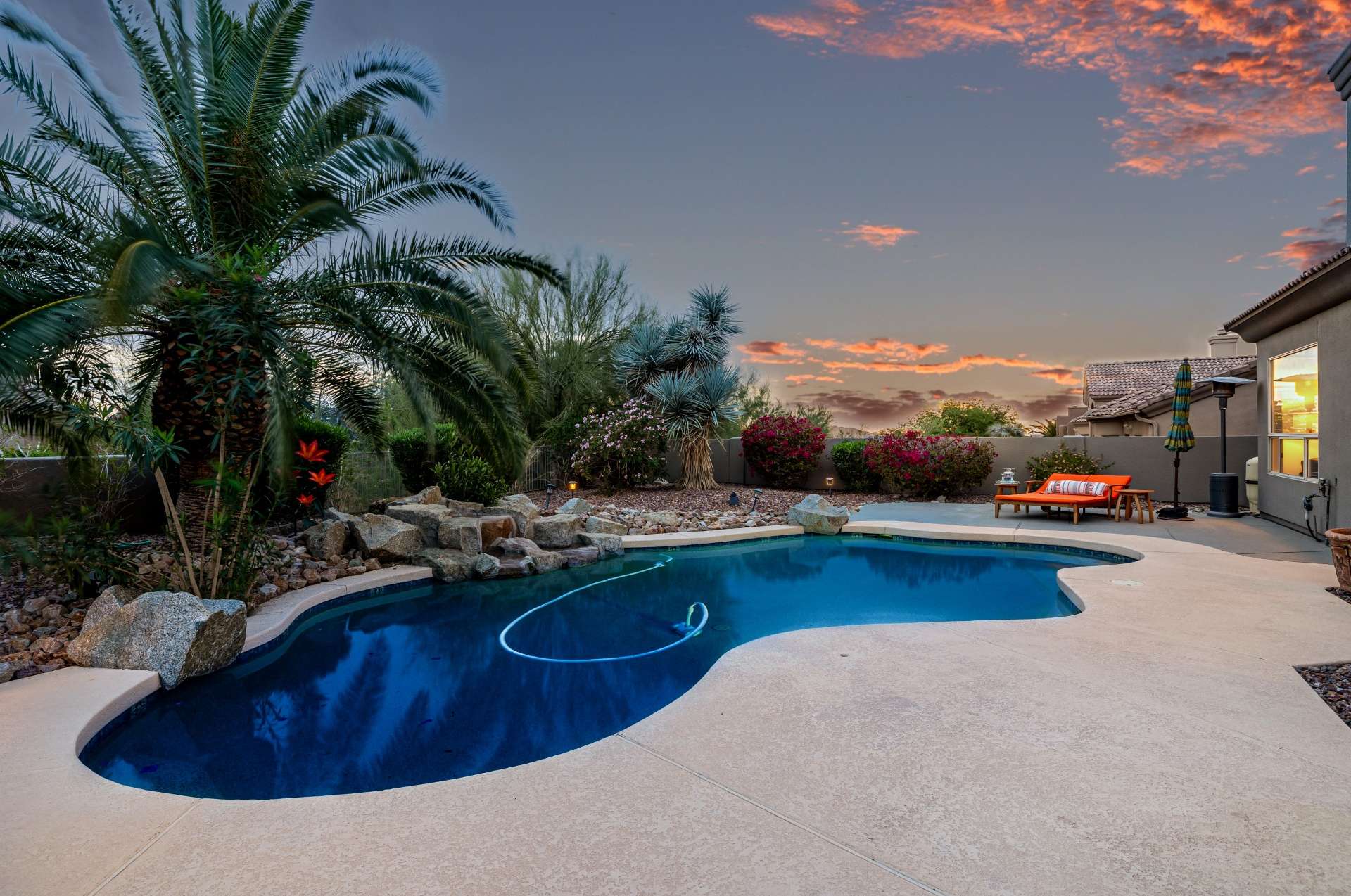 48 of 65. Framed by flowering shrubs and desert palms, this poolscape captures the essence of twilight luxury. Relax in style with soothing water features, natural stone accents, and an entertainer s layout that s picture perfect.