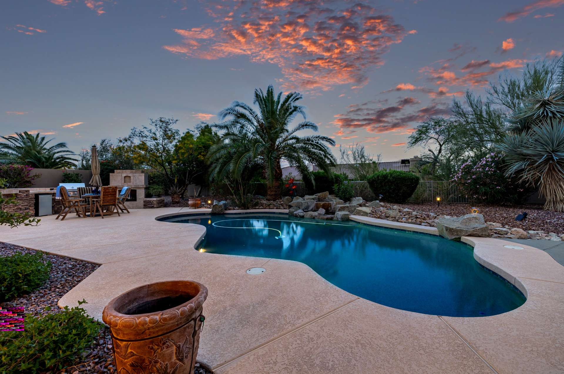 49 of 65. From the curved pool edges to the surrounding natural rock elements, this backyard radiates a serene, upscale resort feel. Twilight ambiance and lush privacy plantings complete the scene, ideal for Scottsdale s year-round lifestyle.