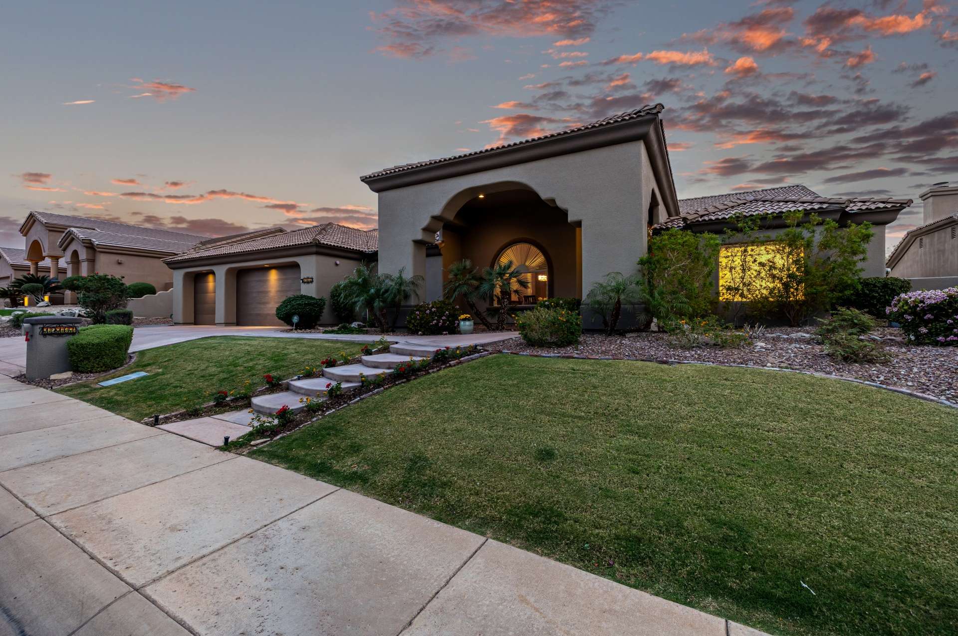 61 of 65. A full view of this home s front fa ade reveals its striking design, perfectly trimmed lawn, and upgraded lighting. This is an inviting, move-in-ready home located in a peaceful community.