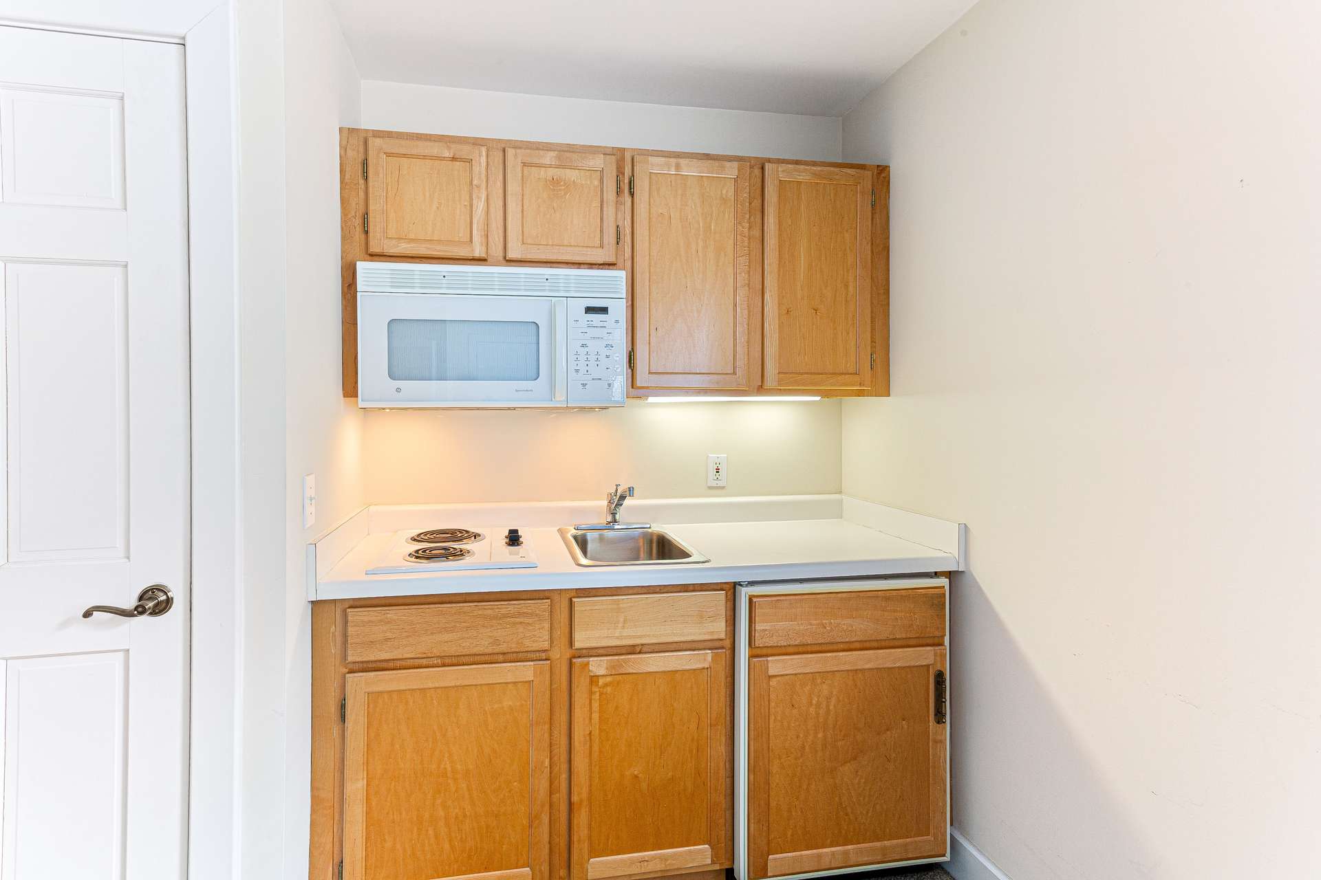 62 of 66. 2nd floor Guest Suite kitchenette with built in cabinets, sink, stove, microwave and refrigerator.