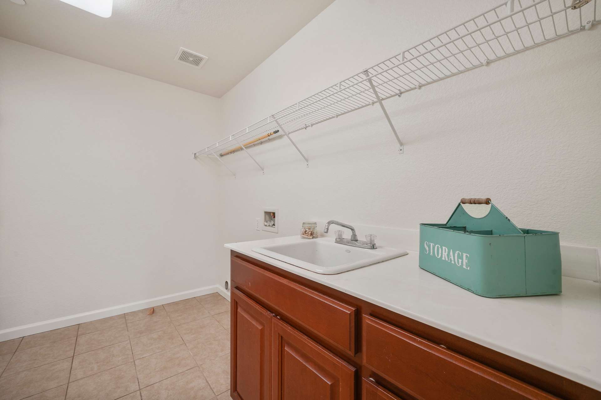 26 of 58. Laundry Room with Utility Sink and Storage