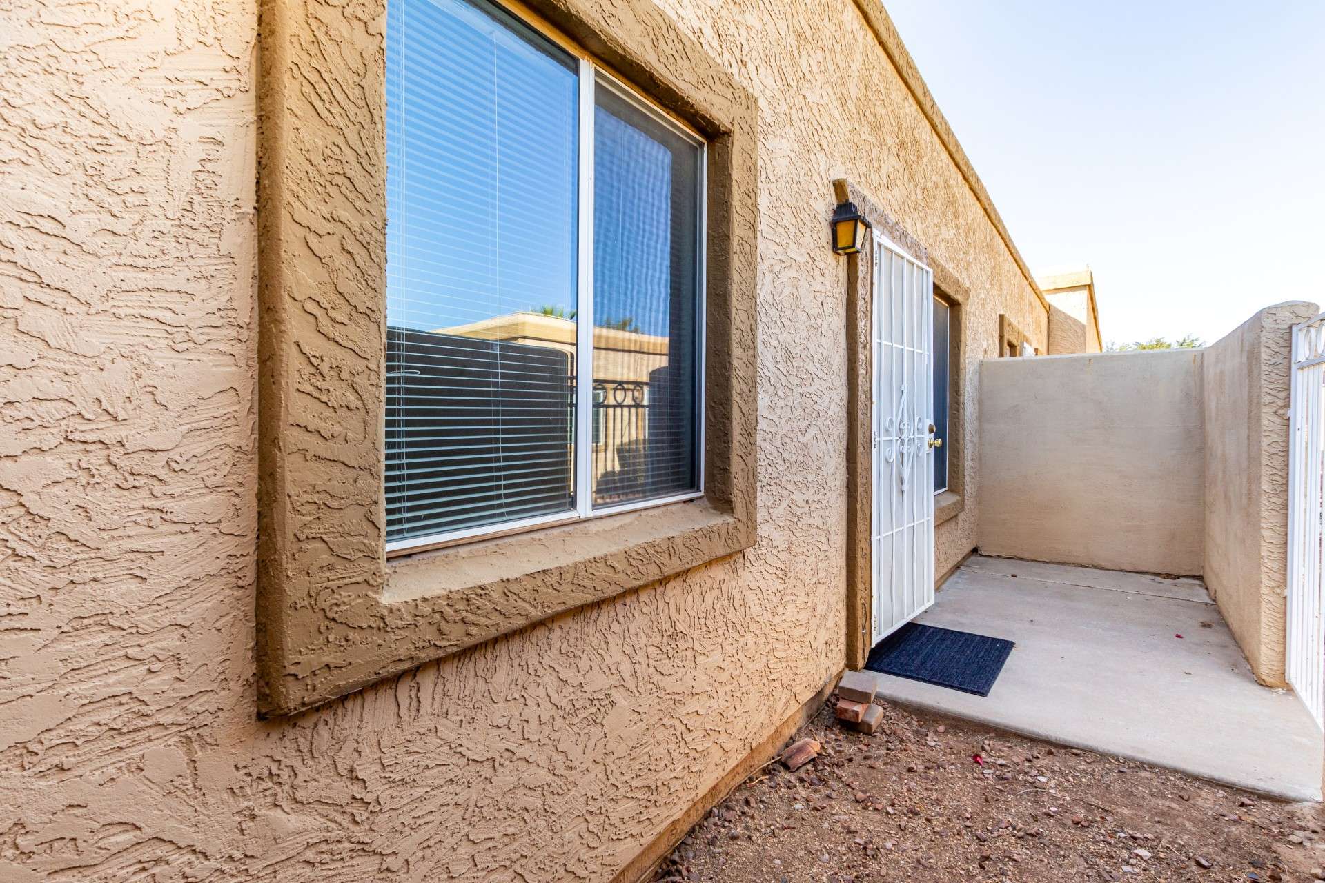 4 of 26. Enjoy the benefits of a private, fully enclosed front patio in this charming Phoenix condo. Whether you're sipping your morning coffee or hosting a guest, this outdoor area provides a secluded, quiet retreat in a central location.