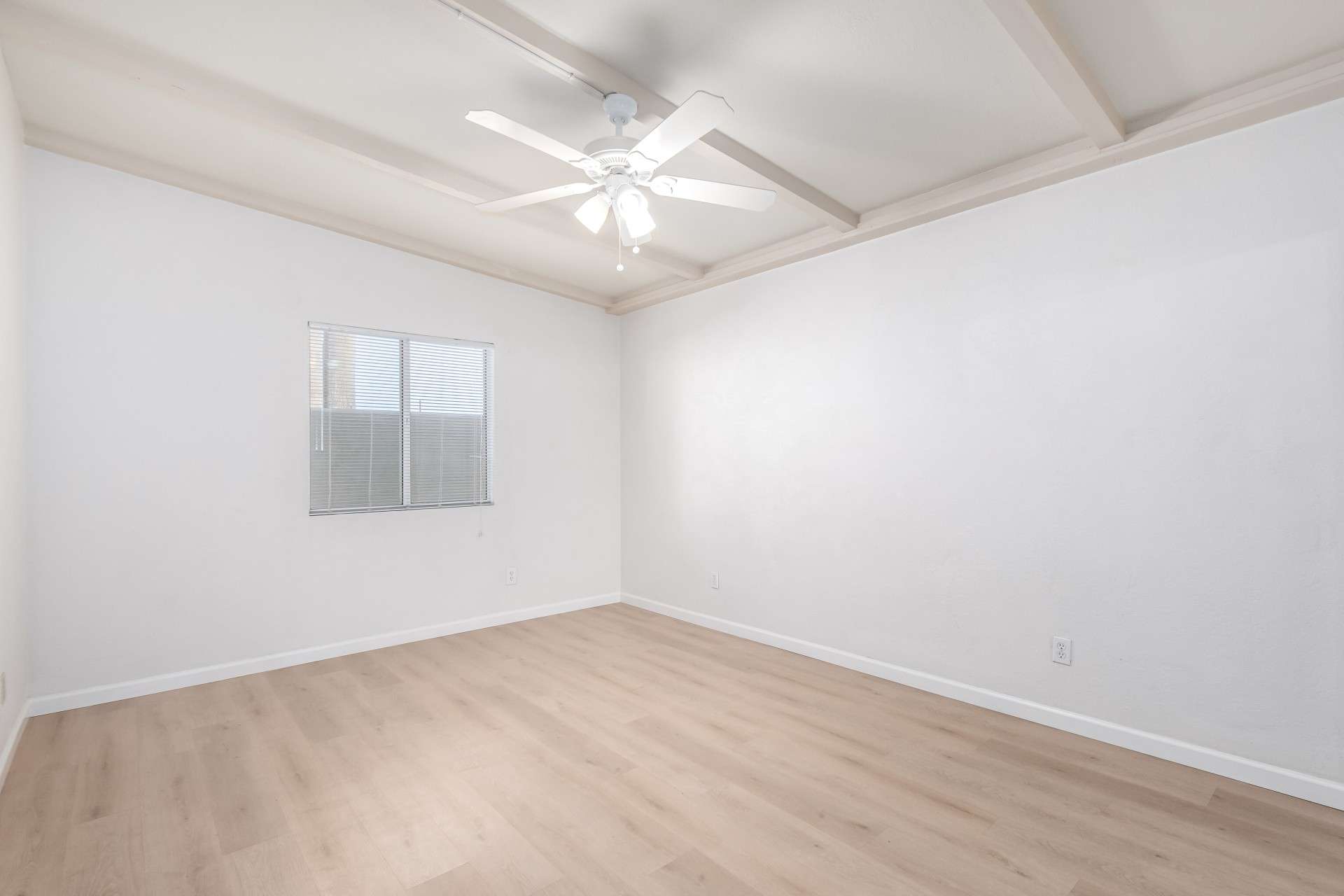 14 of 26. This bright and airy bedroom features high ceilings, fresh flooring, and a ceiling fan for added comfort. Natural light fills the space, creating a relaxing retreat in a well-maintained Phoenix community.