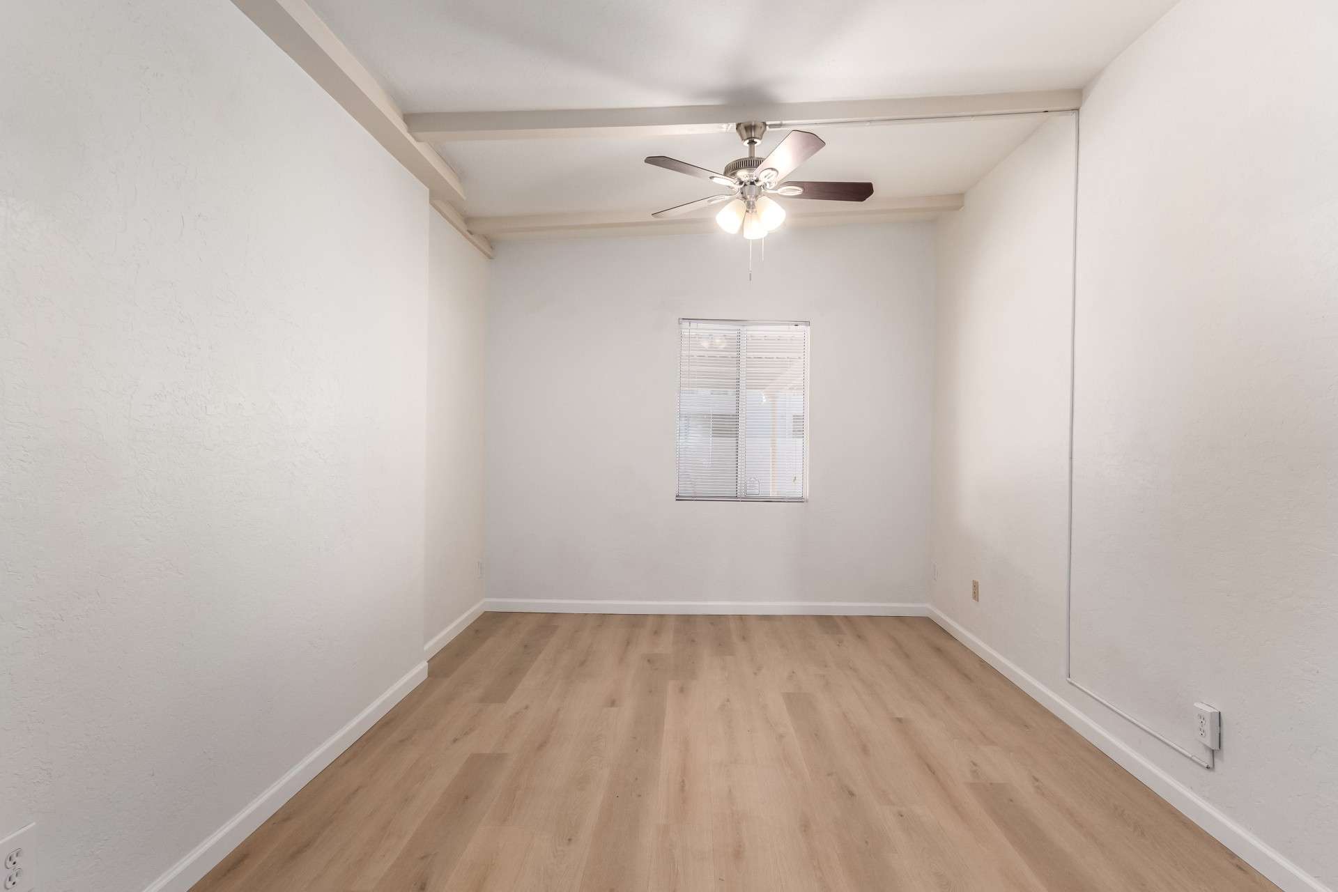 19 of 26. This spacious bedroom offers double closets, stylish flooring, and bright lighting. Its neutral color scheme and vaulted ceilings make it easy to personalize, ensuring a comfortable and inviting atmosphere.