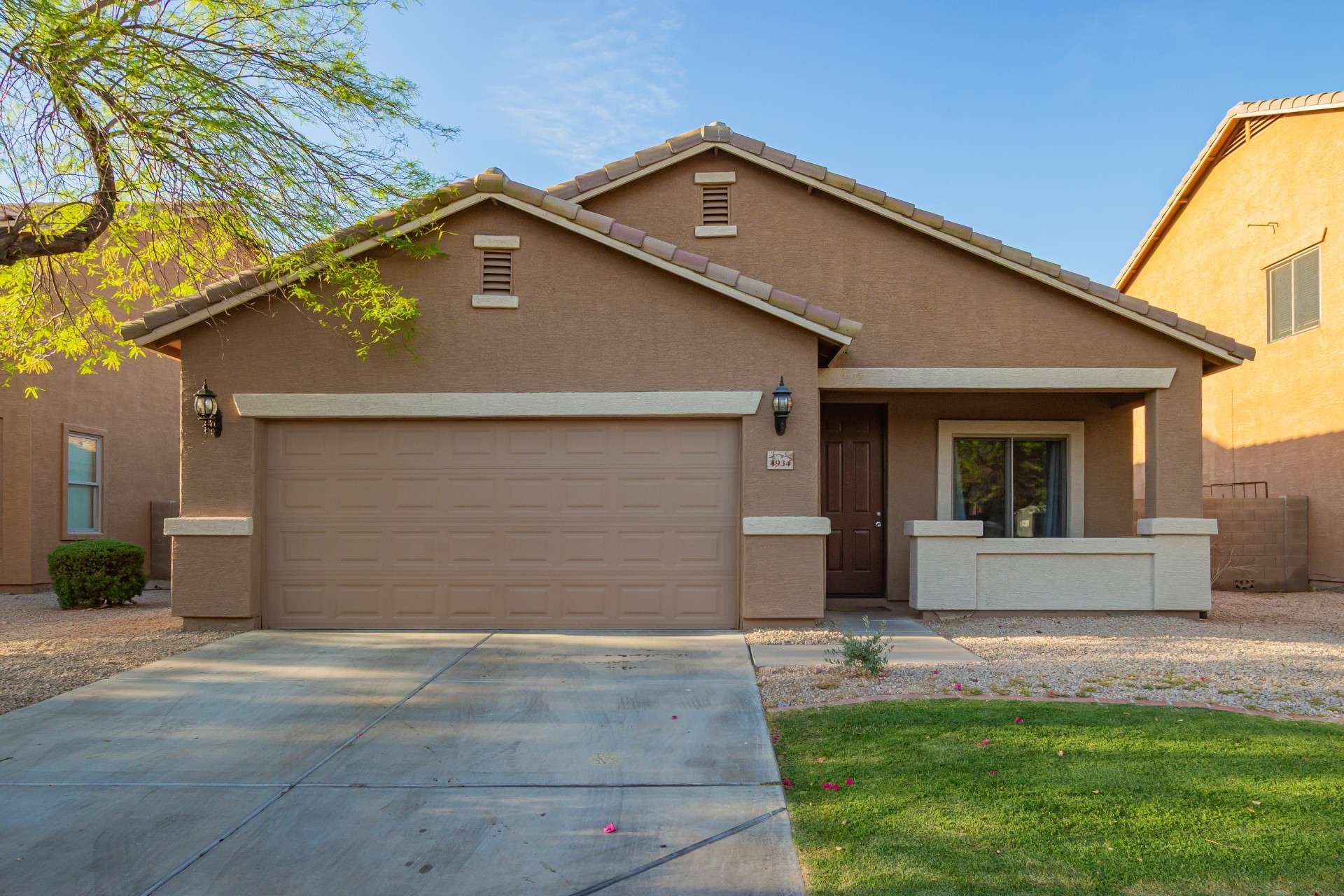 29 of 37. Step up to a warm, welcoming entry framed by modern stucco design, upgraded coach lights, and fresh desert landscaping. This home offers both charm and practicality for Phoenix living.