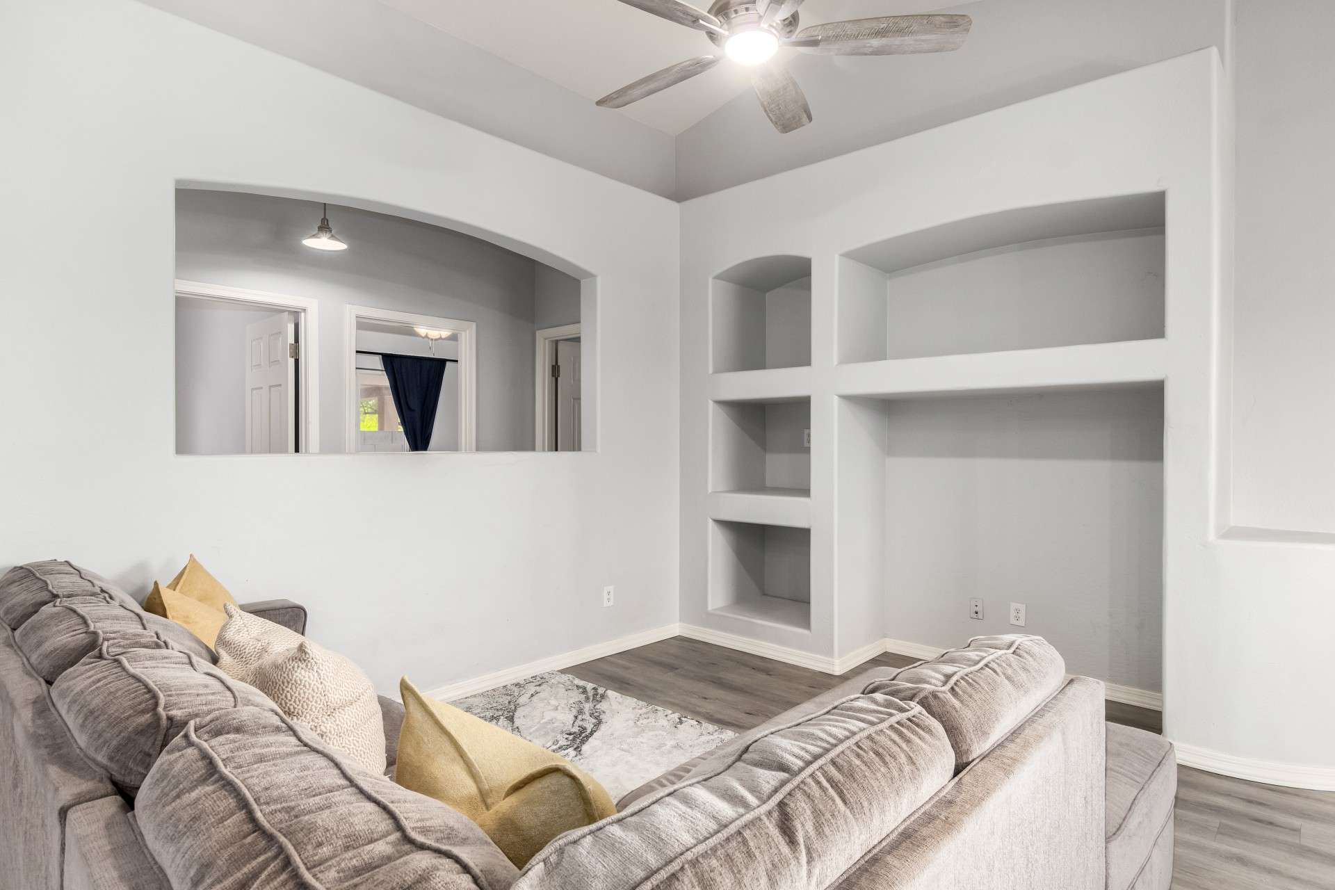 9 of 37. This spacious family room boasts high ceilings and custom wall niches for decor or entertainment. The open layout and crisp finishes enhance both form and function for modern living.