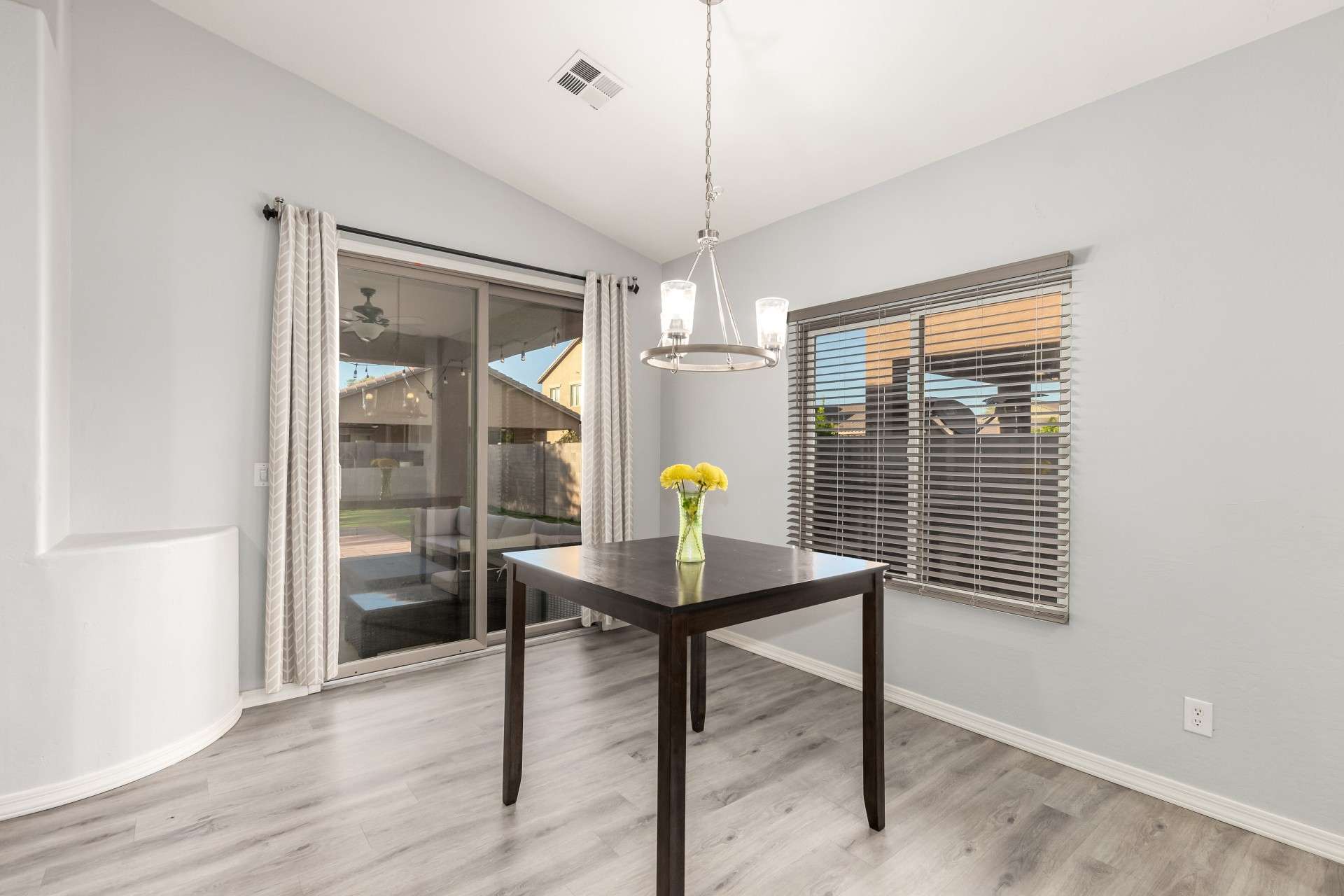 6 of 37. The dining space is bathed in light from the large windows and sliding glass door that leads to a private backyard. Easy access to outdoor entertaining makes this space perfect for hosting or casual dining.