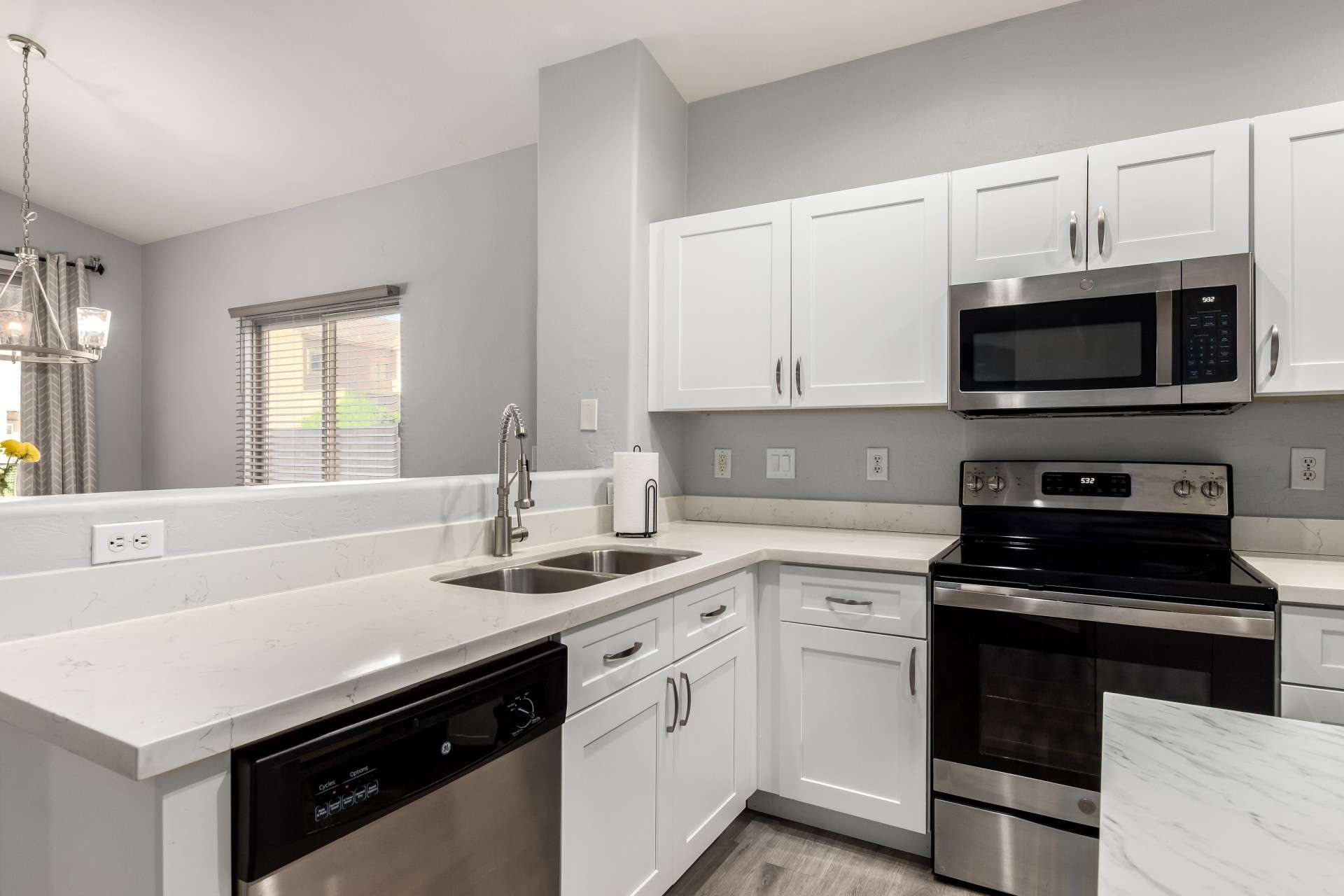 3 of 37. This freshly updated kitchen includes shaker cabinets, a full appliance suite, and expansive countertop space. It's a well-organized hub for culinary creativity and modern convenience.