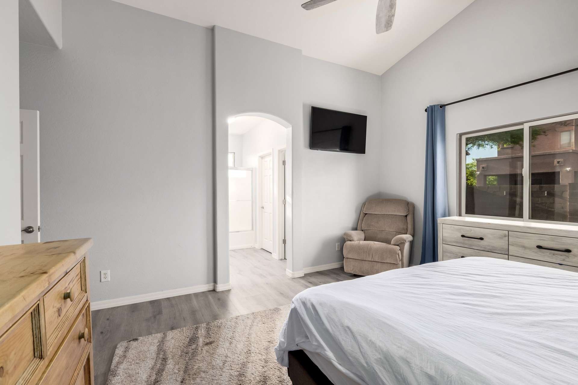 18 of 37. The primary bedroom is filled with natural light and features tall ceilings, soft neutral tones, and sleek flooring. This space offers a calm, quiet escape in a well-designed layout.