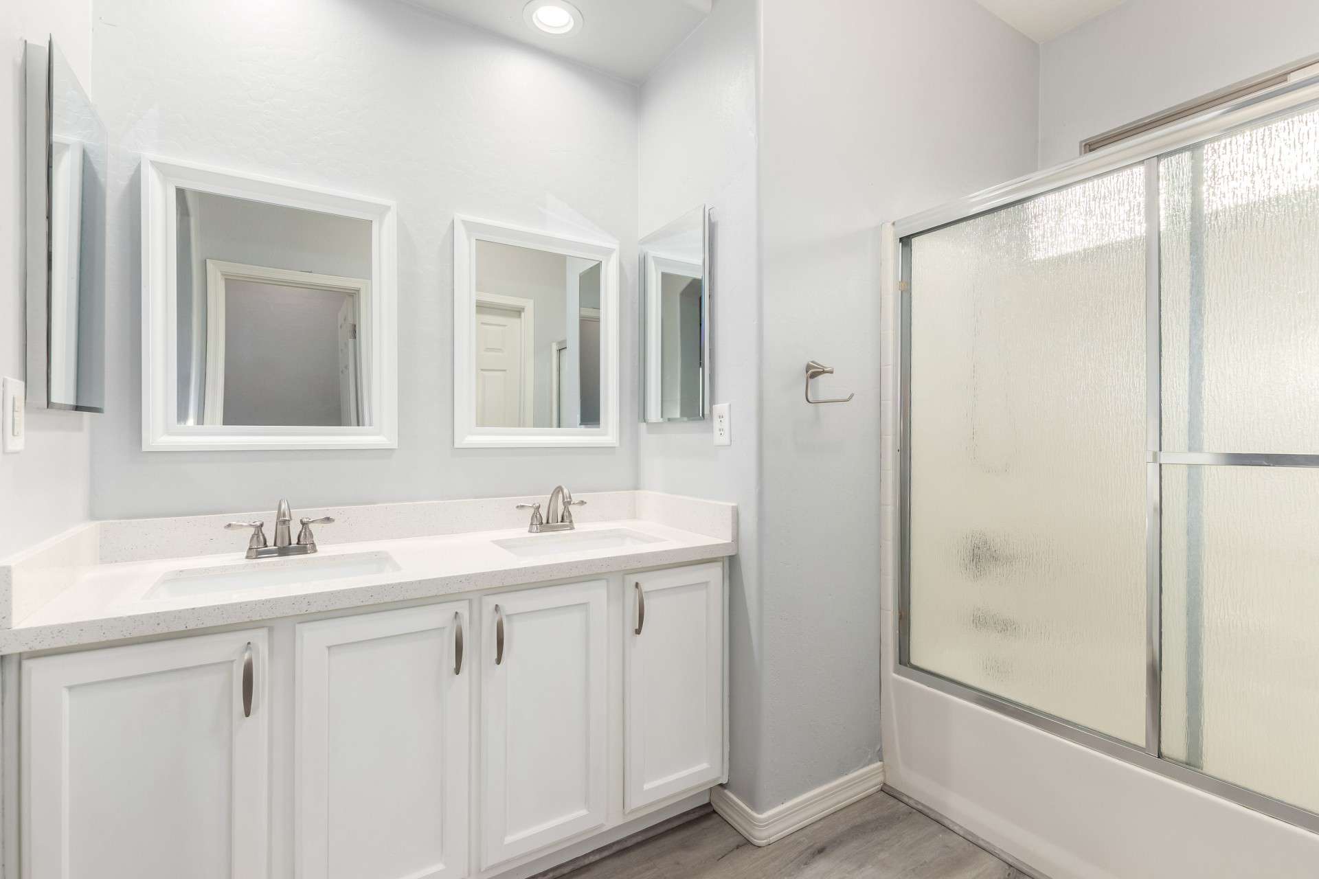 19 of 37. This updated ensuite bathroom includes a dual vanity with quartz counters, framed mirrors, and chrome fixtures. A full tub/shower combo adds both function and style for everyday use.