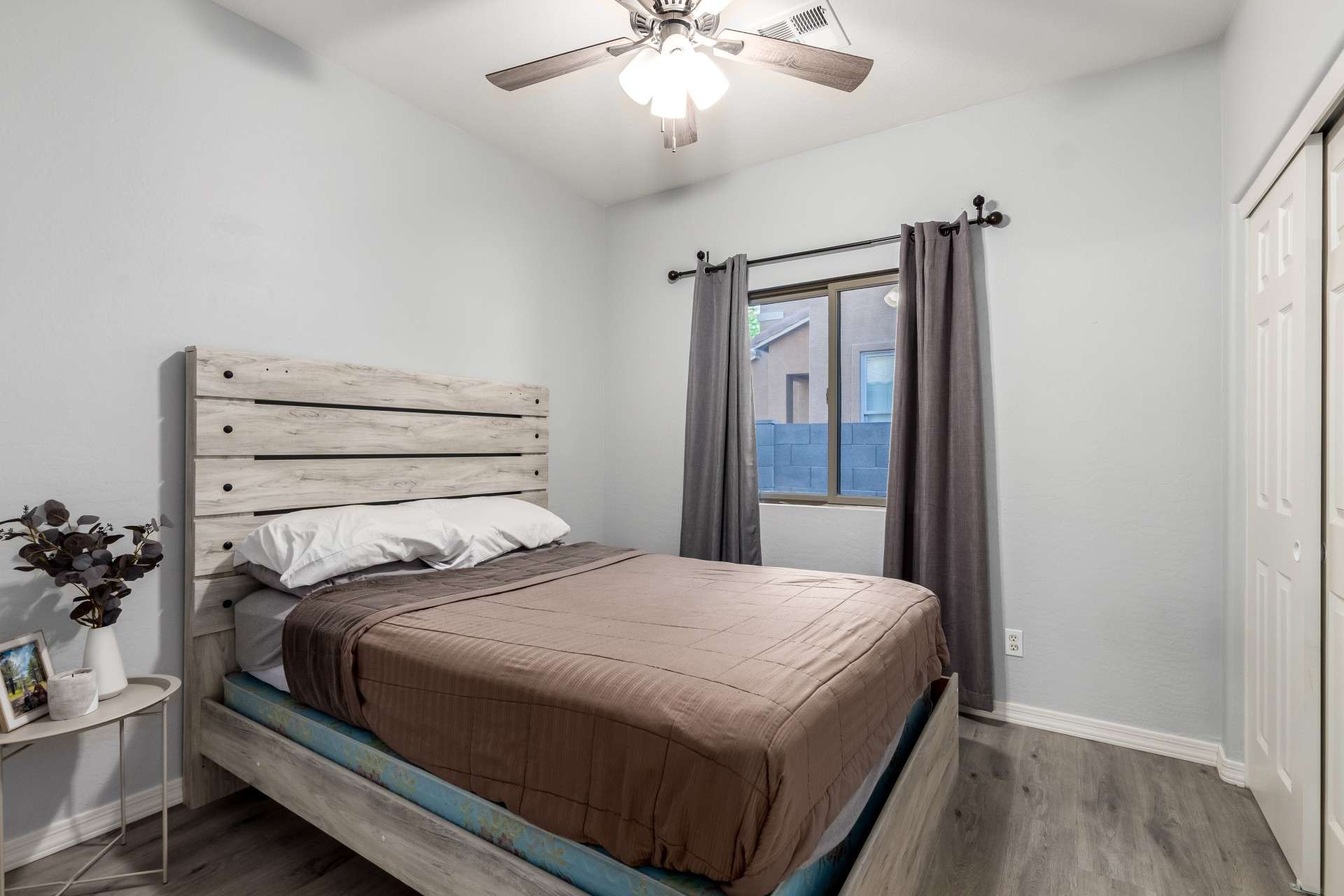 20 of 37. A well-proportioned guest bedroom offers rich-toned flooring, clean white trim, and a large window. It's move-in ready, ideal for guests, kids, or additional office space.