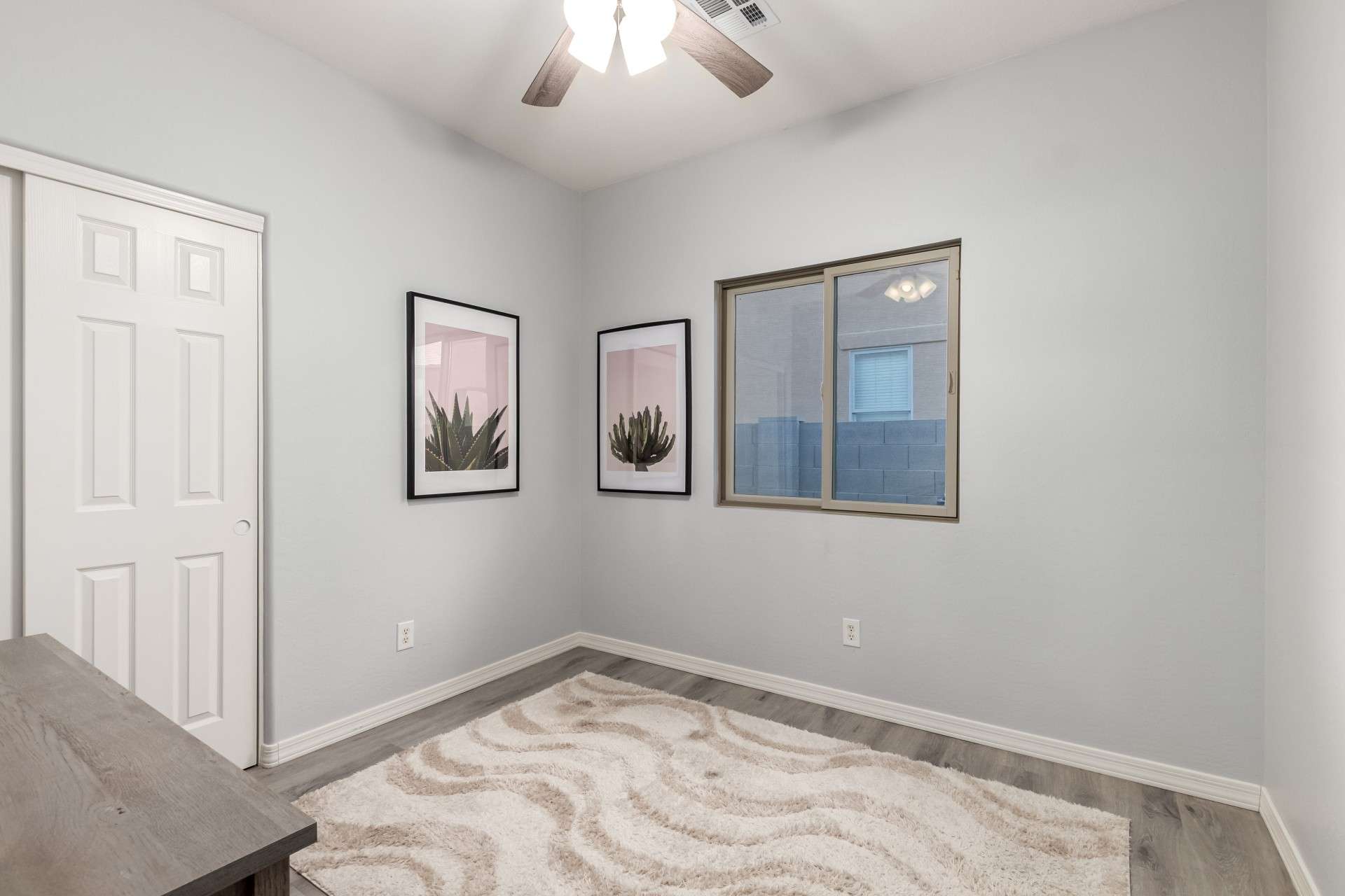 22 of 37. This dedicated home office features plank flooring, soft gray walls, and ceiling fan comfort. The neutral aesthetic makes it easy to personalize and use as a quiet workspace or studio.