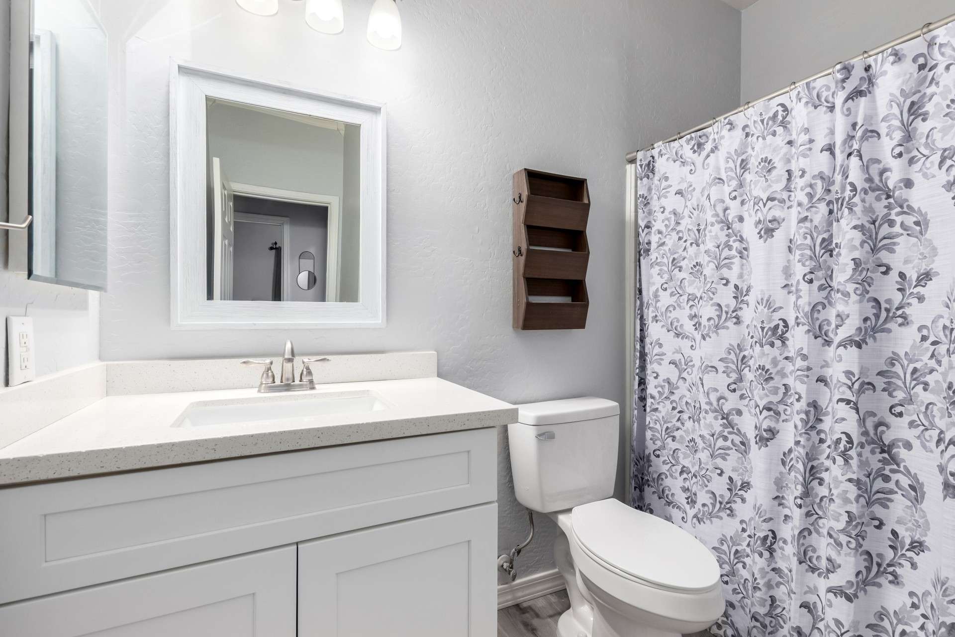 26 of 37. The hall bathroom is fresh and functional, featuring an upgraded vanity, framed mirror, and modern hardware. Perfect for guests or shared use, it delivers style and convenience in every detail.