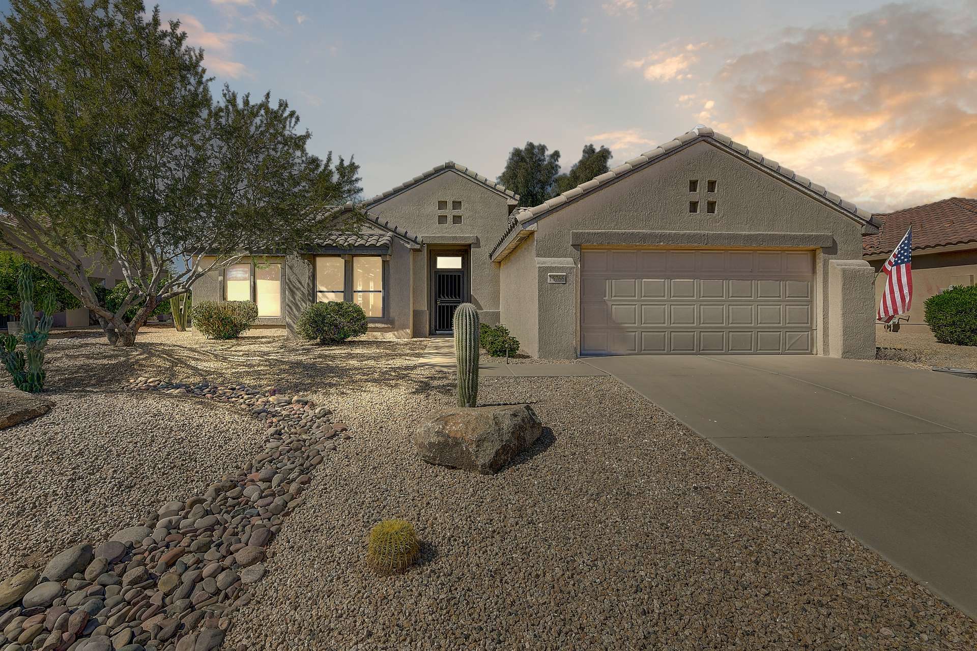 1 of 35. Featuring mature desert flora and drought-friendly rock accents, the front yard delivers exceptional curb appeal with low-maintenance benefits. The stucco exterior and paver-lined walkway create a welcoming entry to this stunning Surprise, AZ home.