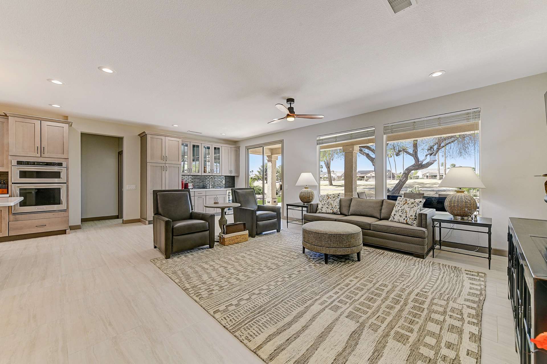 5 of 35. Wall-to-wall windows and seamless indoor-outdoor connection make this living space the ultimate in golf course living. A private backdrop, custom wet bar, and upgraded lighting elevate this room into a refined desert haven.