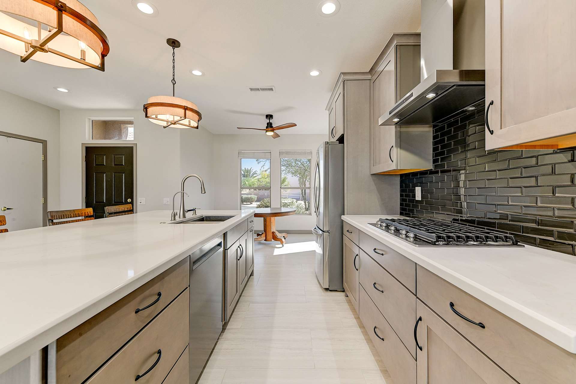 10 of 35. From double wall ovens to upgraded hardware and tile accents, this remodeled kitchen exudes thoughtful craftsmanship. Sleek cabinetry and quartz surfaces deliver style and durability in one of Surprise s most elegant homes.