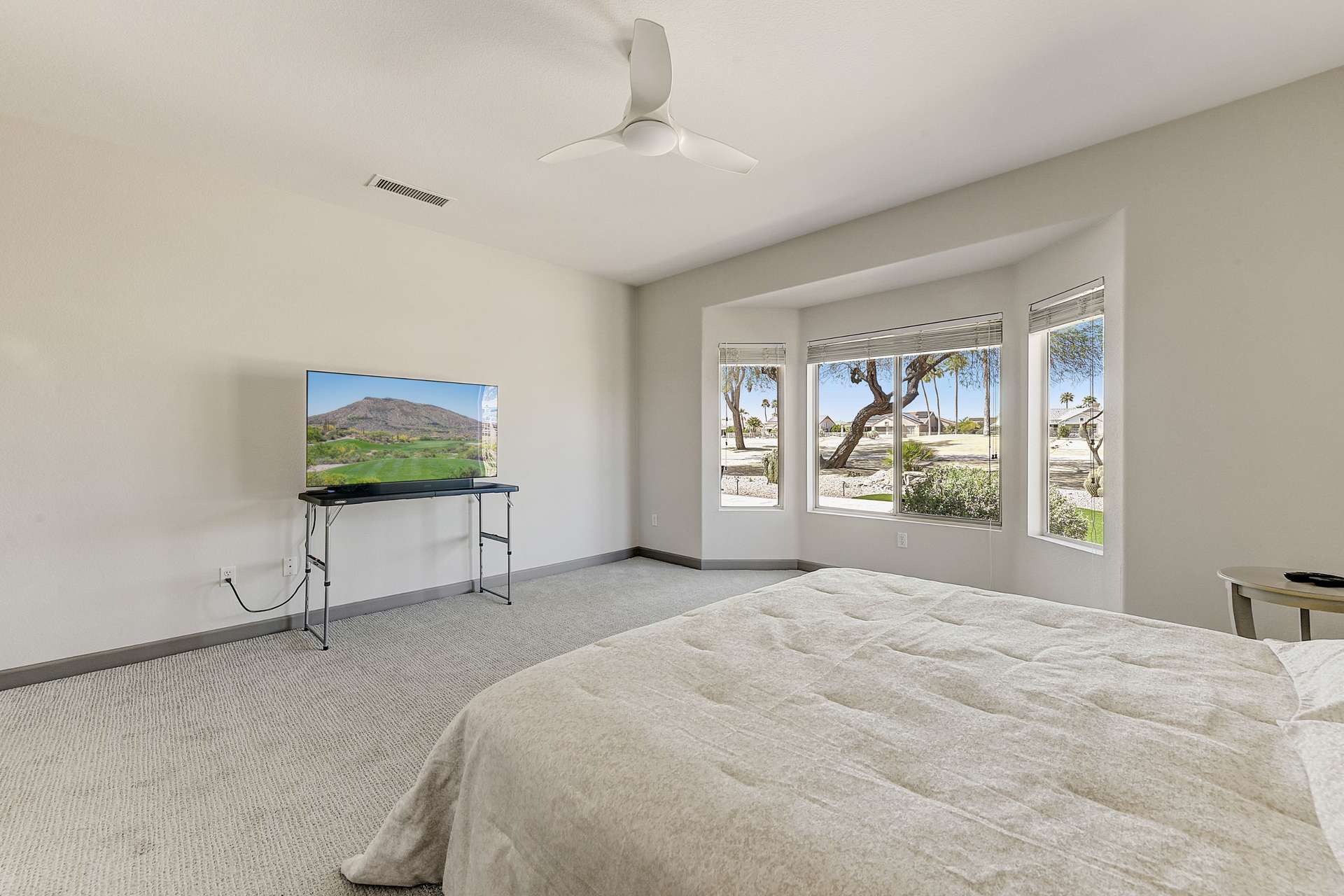15 of 35. This oversized bay window brings in natural sunlight and panoramic golf course scenery. It s a standout architectural feature that enhances both the beauty and the ambiance of the primary bedroom.