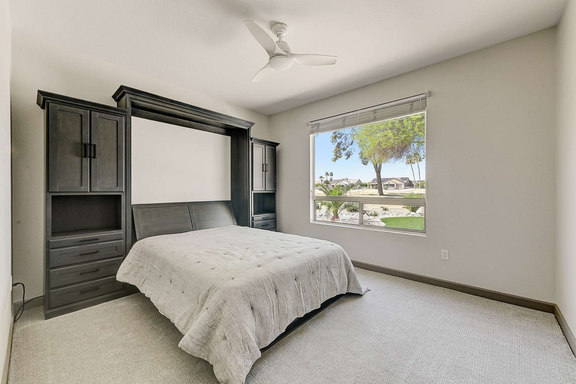 20 of 35. The second bedroom includes a custom Murphy bed with built-in storage perfect for guests, hobbies, or a home office. Golf course views and neutral tones make this flexible space both practical and inviting.
