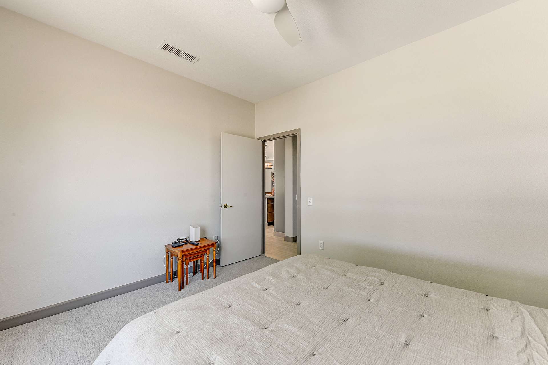 21 of 35. This secondary bedroom offers a restful space with soft tones and plush carpeting. Tucked away near the heart of the home, it's perfect for overnight guests or a quiet workspace.