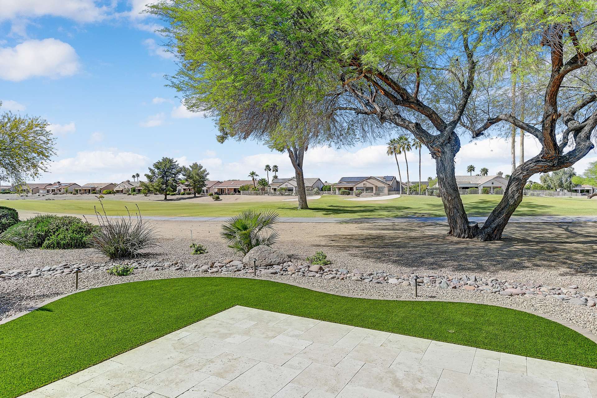 26 of 35. Professionally landscaped with desert plants and lush turf, this backyard offers expansive golf course views, perfect for morning coffee or peaceful sunsets.