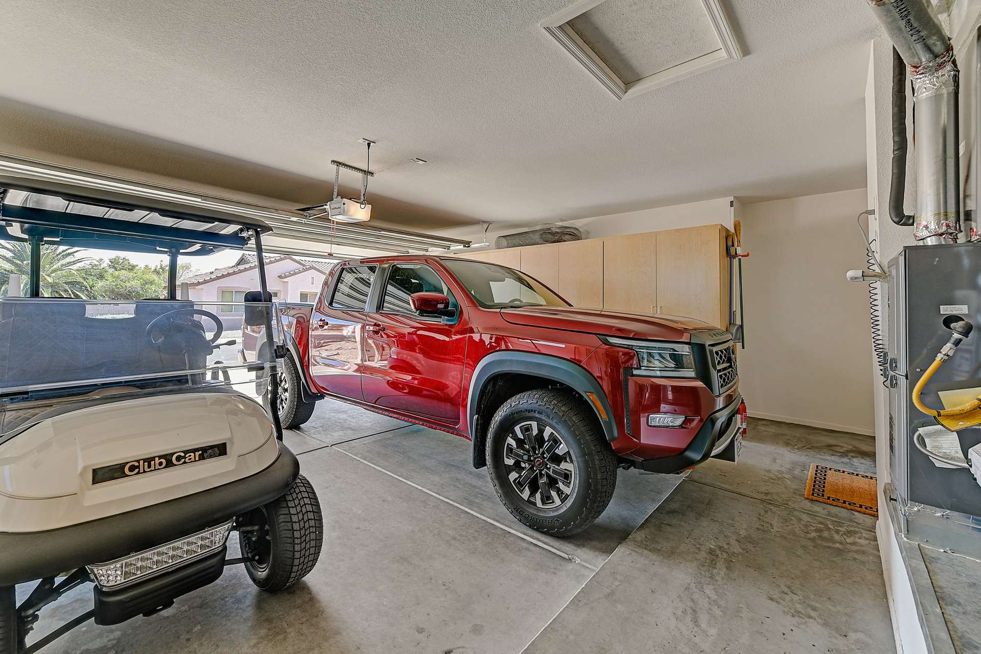 29 of 35. Roomy enough for vehicles and your golf cart, this two-car garage features added storage cabinetry perfect for active lifestyles in beautiful Surprise, AZ.