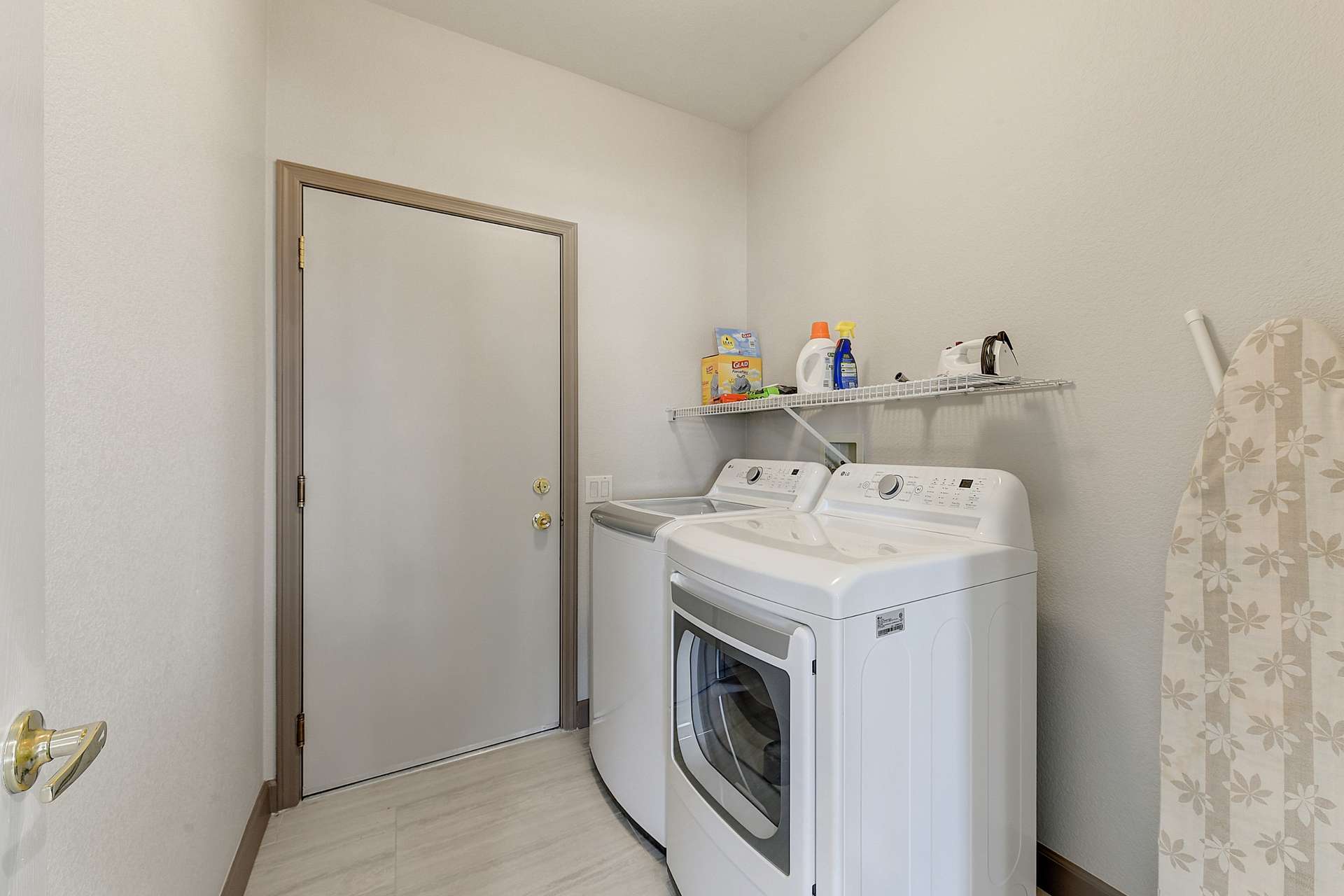 30 of 35. The interior laundry room offers full-size washer and dryer units, shelving, and access to the garage making household routines smooth and convenient.