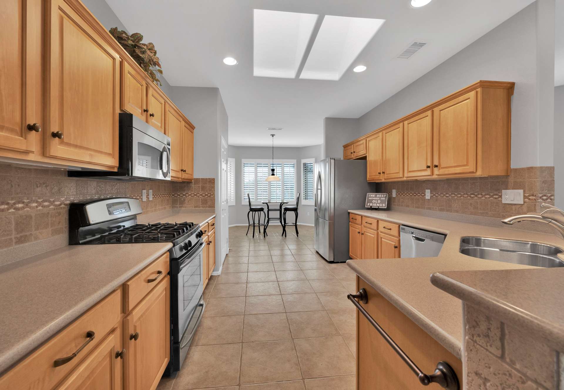 3 of 13. Highlighted by a gas range, stainless steel appliances, and rich wood cabinetry, this fully stocked kitchen is a dream for summer renters who love cooking at home in Surprise.