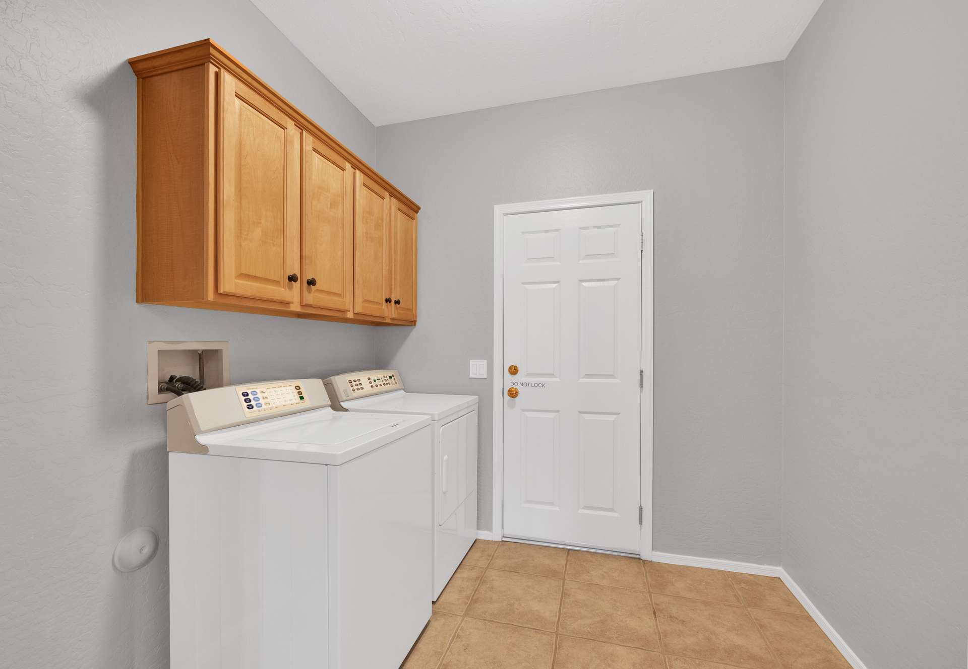 13 of 13. The home s interior laundry room includes a washer, dryer, and upper wood cabinets offering everyday convenience and organized storage for your short-term or seasonal stay in Surprise, Arizona.
