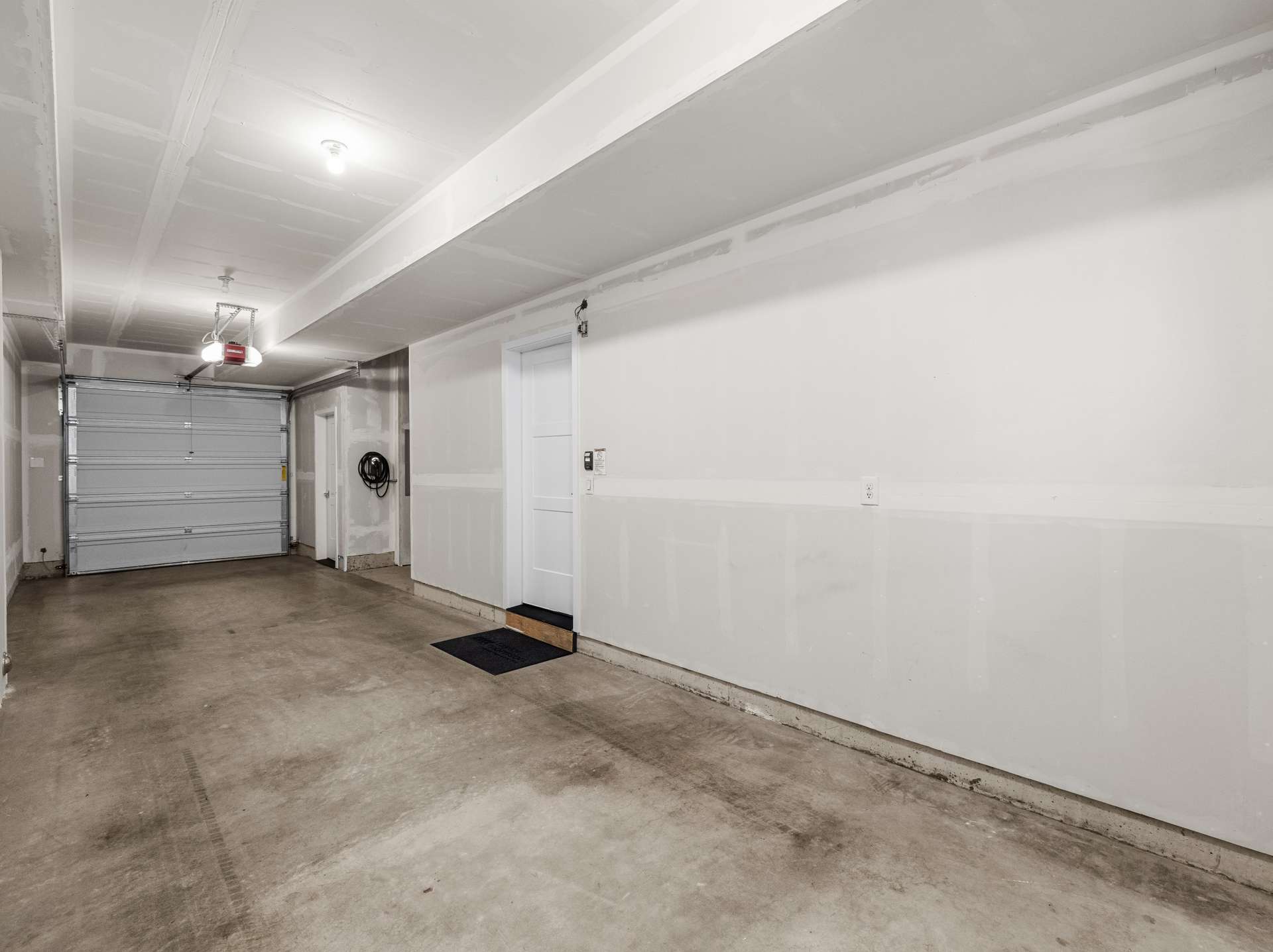 26 of 41. Tandem 2-Car Garage with EV Charger, Heated Storage Closet, Indoor Spigot and Extra Storage Space