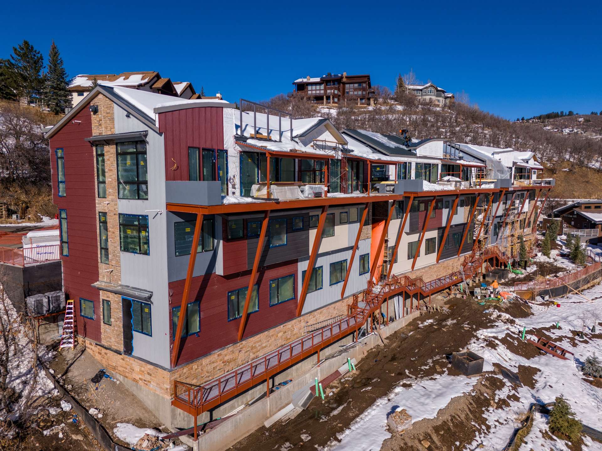 9 of 27. New construction featuring stone and metal exterior. Reinforced steel for the future balconies in place