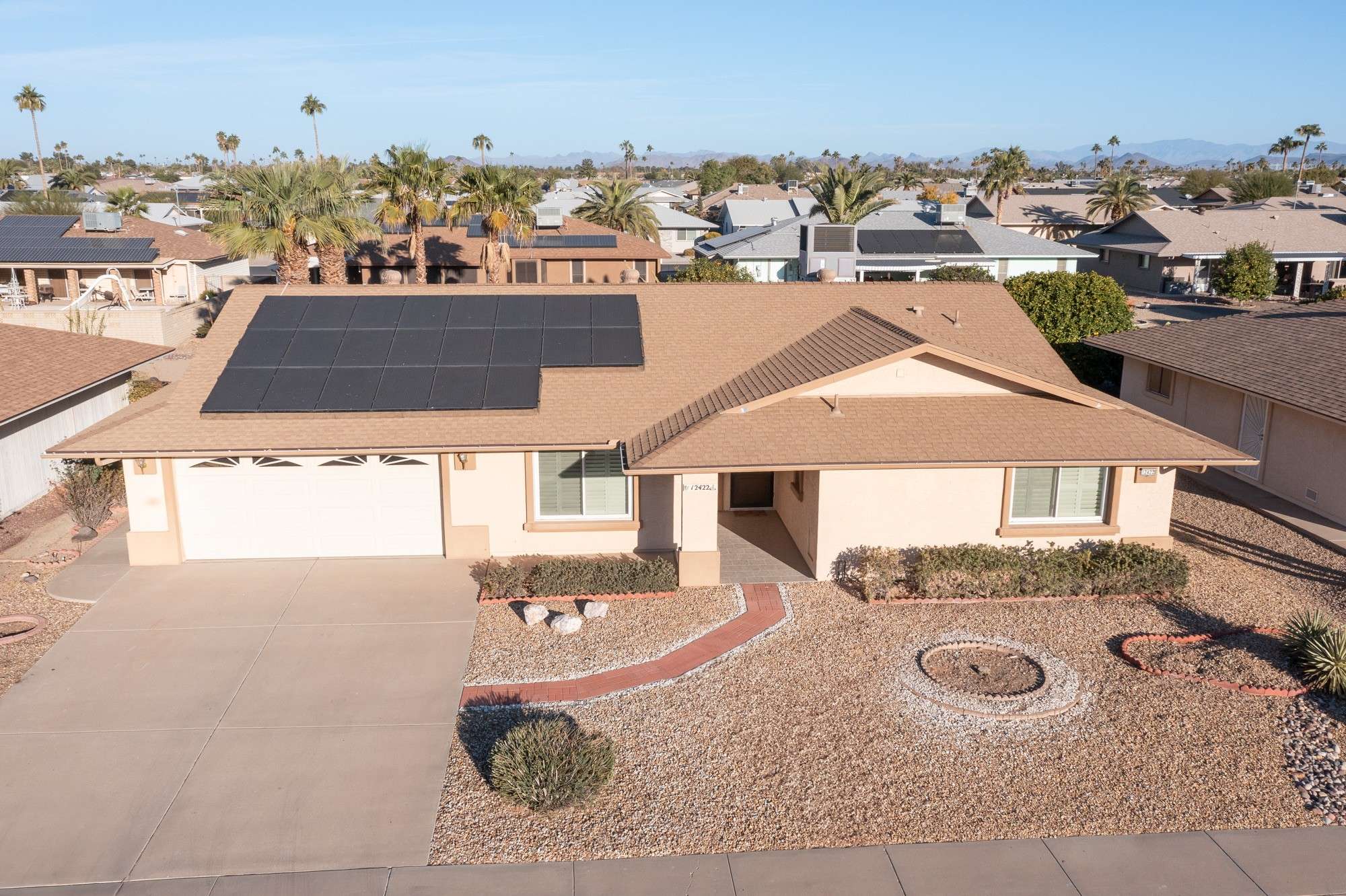 9 of 48. A rooftop shot highlighting the home's fully paid solar panels and 2018 roof upgrade. This energy-conscious property is a perfect example of sustainable living in Sun City West.