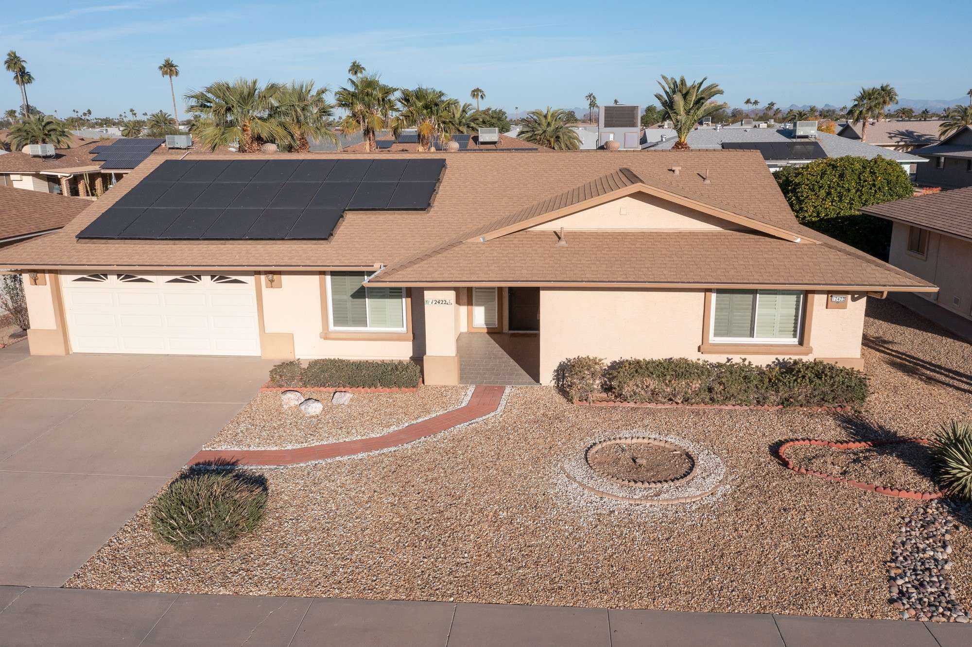 1 of 48. Highlighting the roof's solar panels and modern upgrades, this photo showcases the energy efficiency of this property, making it a standout choice in Sun City West.