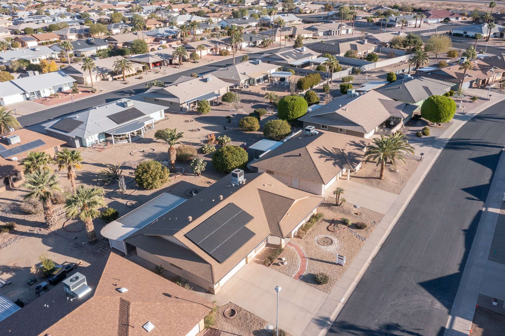 11 of 48. A breathtaking aerial view of Sun City West, highlighting its pristine homes, desert landscaping, and thoughtfully designed community layout. Ideal for those seeking tranquility in Arizona's serene desert environment.