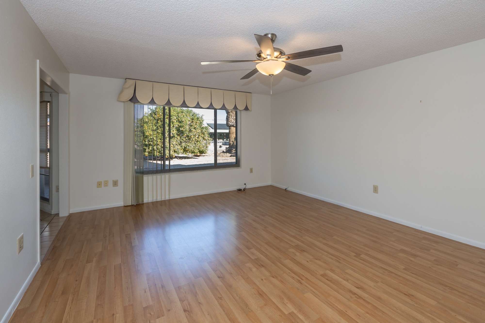 34 of 48. A charming dining area with tiled floors and sliding glass doors that open to a covered patio, creating an ideal indoor-outdoor dining experience.