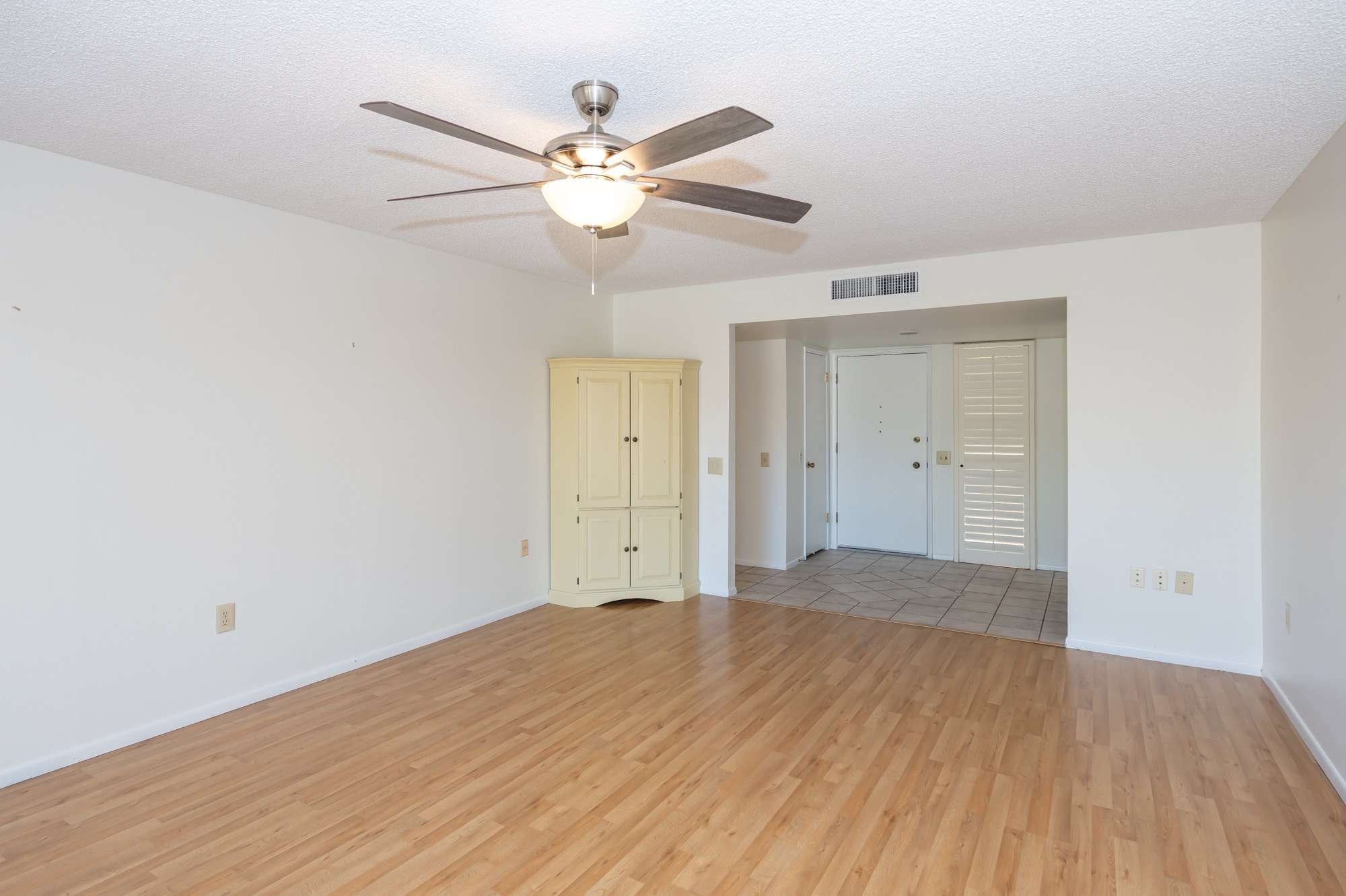 35 of 48. This modern kitchen boasts white cabinetry, a built-in microwave, and a bright design. Perfect for meal preparation, it also connects seamlessly to the dining area.