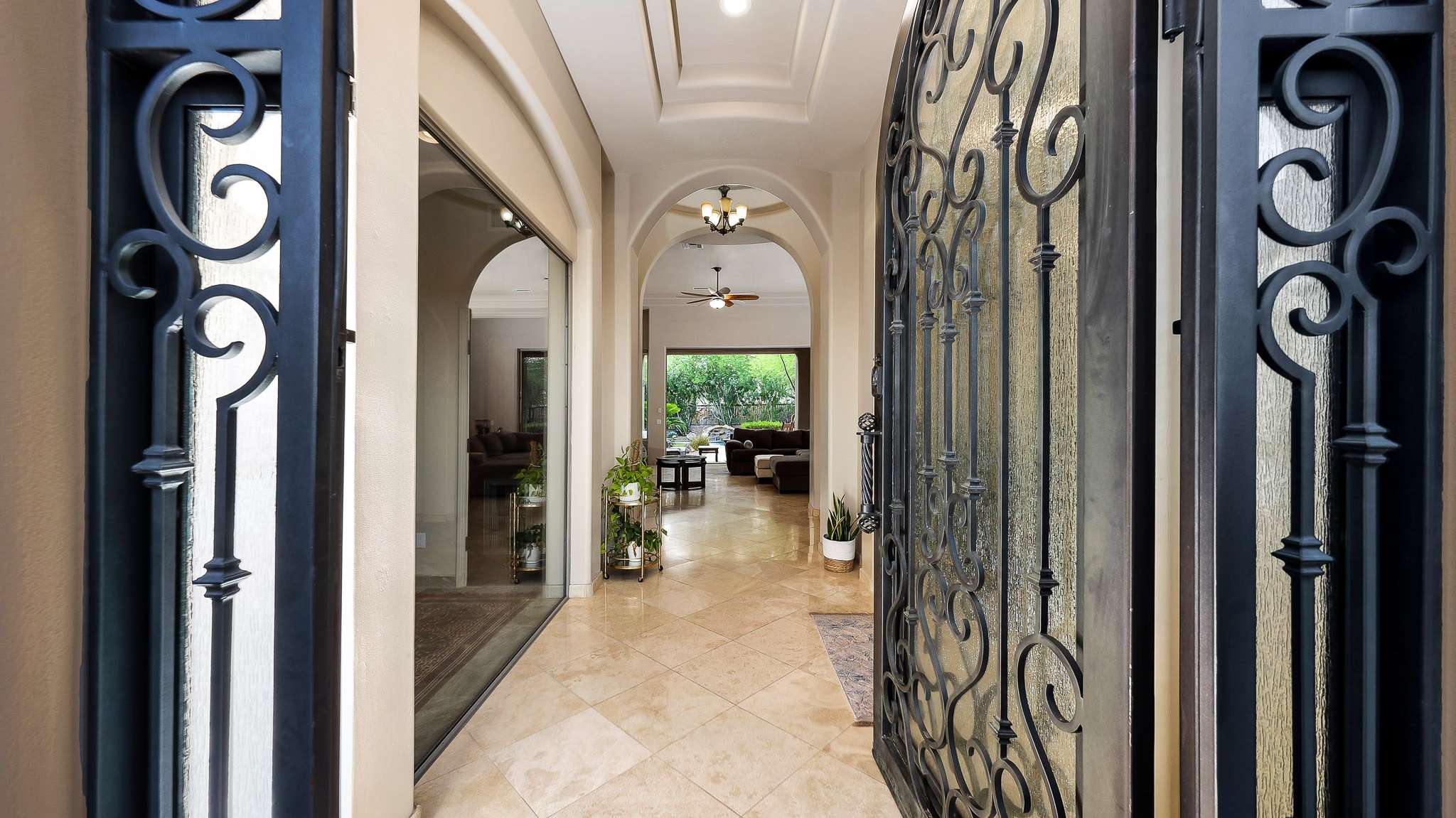 6 of 39. Enter through ornate wrought iron doors into a soaring foyer with polished tile floors and archways leading into the heart of the home. The Scottsdale layout flows seamlessly from front to back.