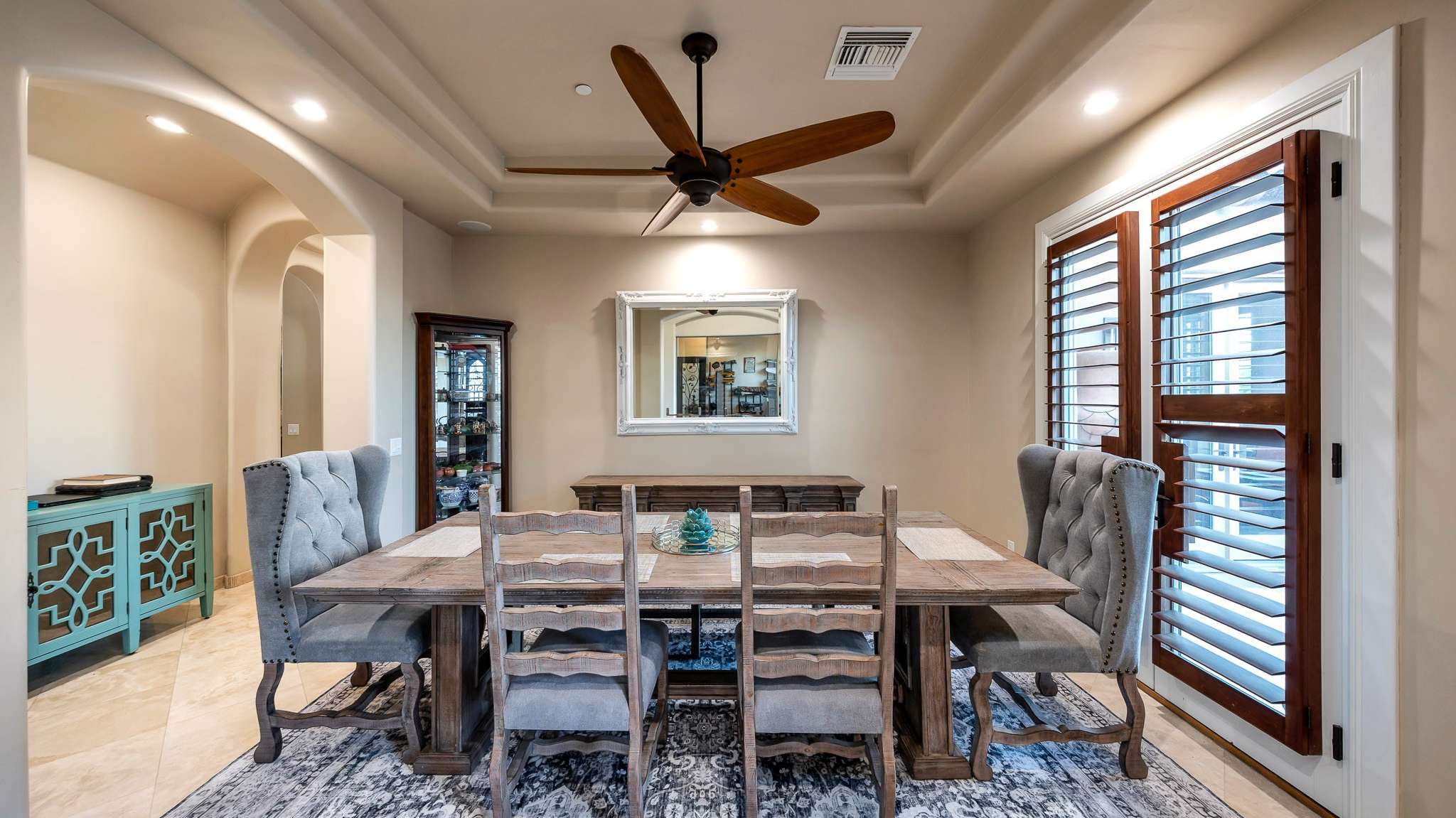 7 of 39. Create lasting memories in this refined formal dining room, complete with tray ceilings, recessed lighting, and oversized shuttered windows. A perfect space for holidays and upscale dinners.