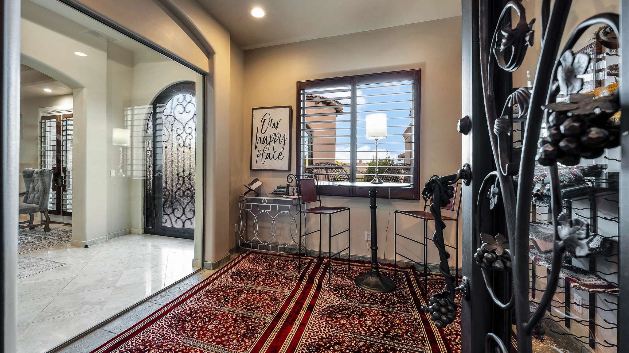 8 of 39. Display your wine collection in a climate-controlled entry wine room with custom ironwork and built-in shelving. This curated space adds luxury and character to the Scottsdale estate s entry experience.