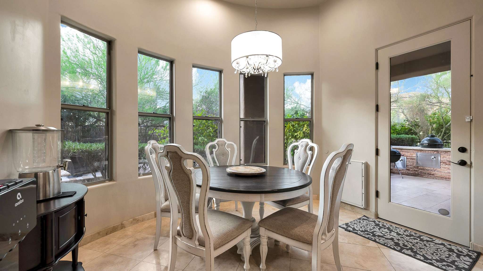 13 of 39. Surrounded by windows, this cozy breakfast nook offers abundant natural light and serene views of the lush Scottsdale backyard. With direct patio access, it s the perfect spot for morning coffee or casual meals.