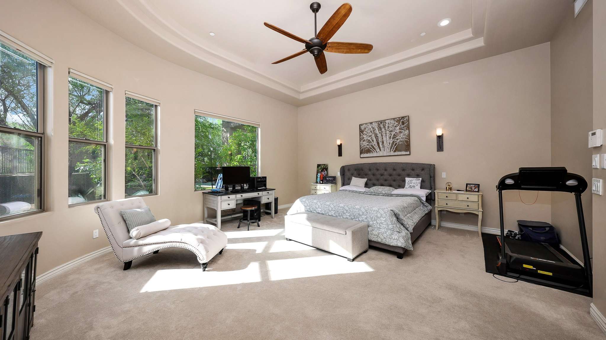 14 of 39. Spacious and bright, the primary suite features tray ceilings, wall-to-wall windows, and neutral tones. This Scottsdale retreat offers comfort and privacy, with plenty of space for a sitting area or workstation.