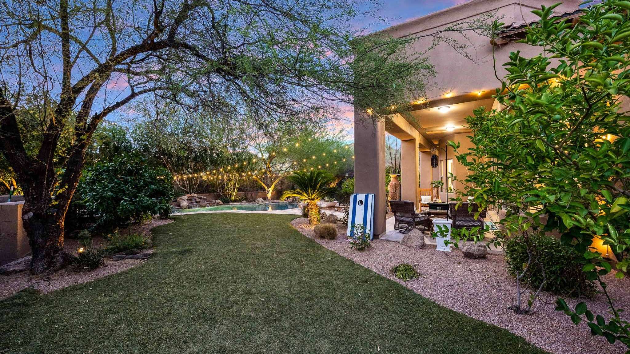 24 of 39. This expansive yard features manicured artificial grass, shaded lounge areas, and elegant lighting. Scottsdale homeowners will appreciate its blend of privacy, space, and desert elegance.