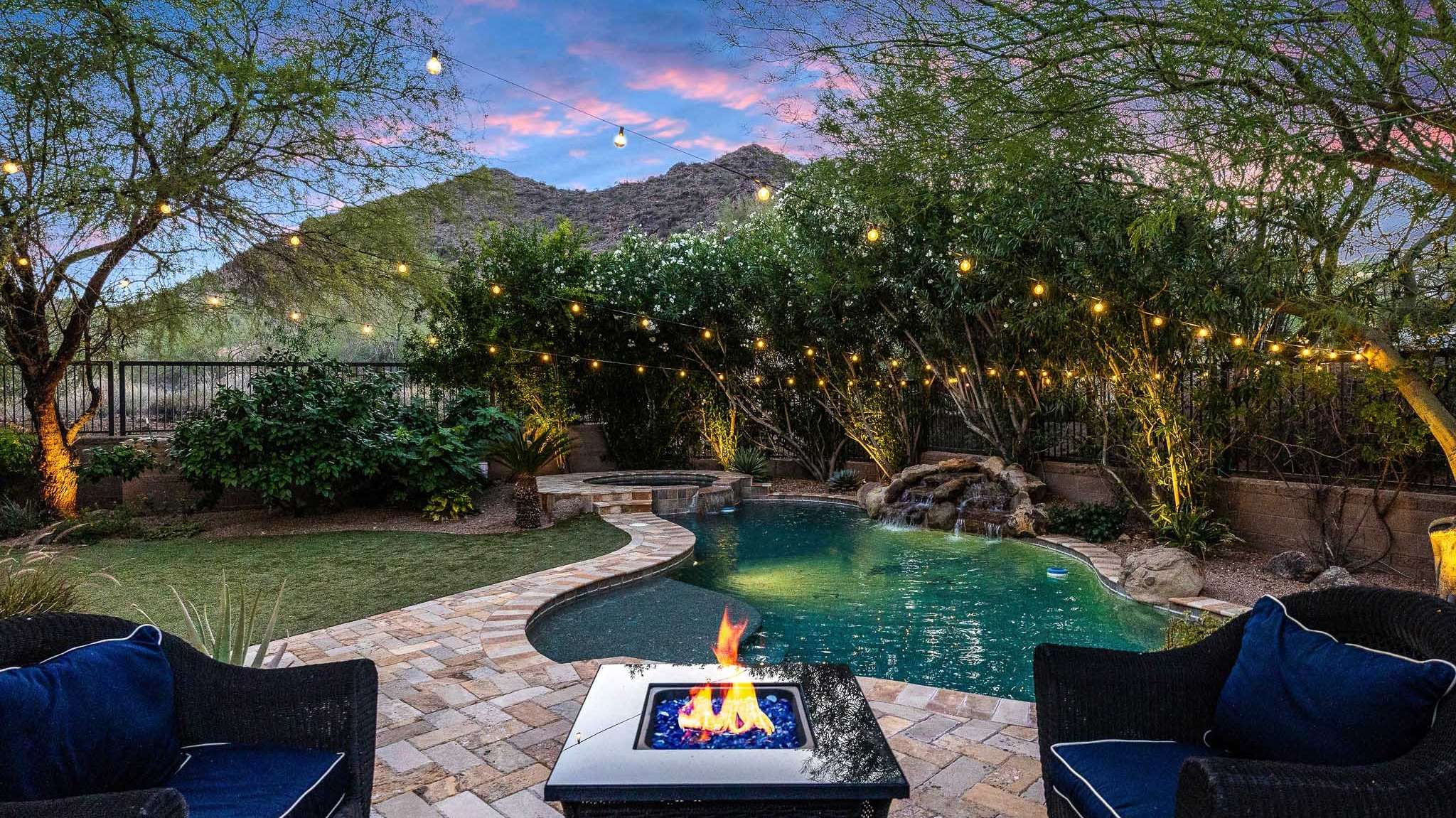 26 of 39. A cozy fire pit anchors this backyard seating area with views of the Scottsdale mountains. Enhanced by poolside lighting and landscape design, it s a perfect setting for intimate nights outdoors.