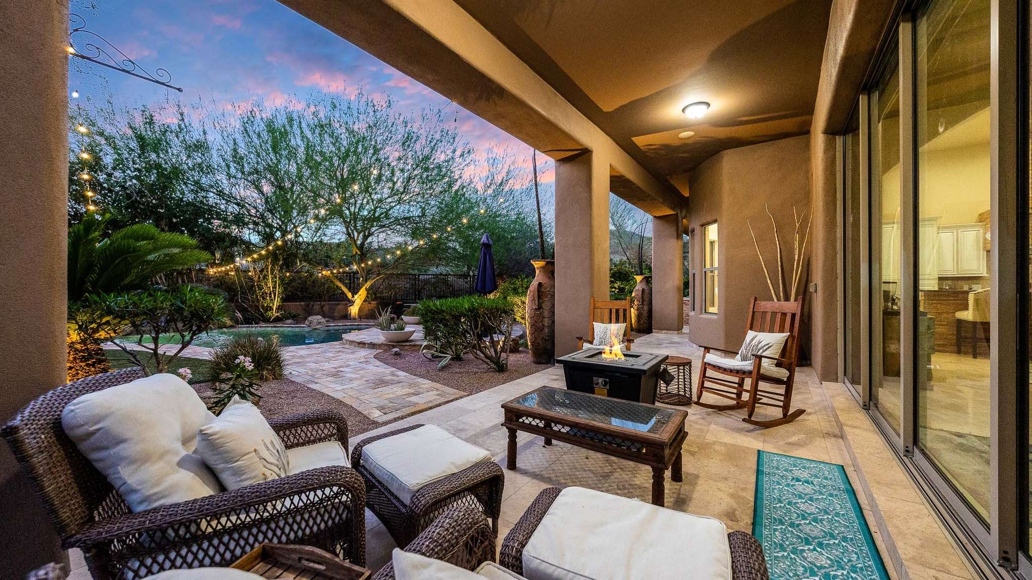 27 of 39. Comfortable outdoor living meets desert charm on this covered Scottsdale patio. Enjoy the glow of the fire feature and pool views while shaded from the sun and surrounded by mature foliage.