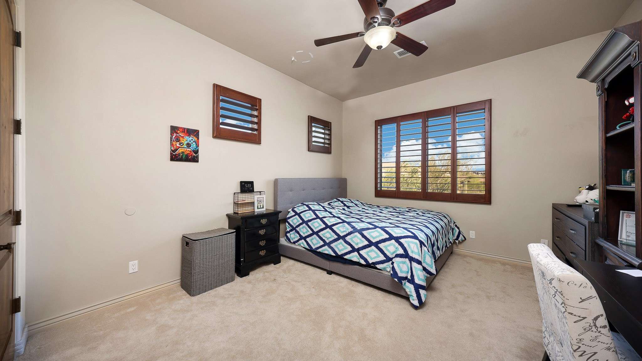 32 of 39. A peaceful space with bright natural light, neutral tones, and wood-shuttered windows. This bedroom offers comfort and flexibility within the well-designed Scottsdale floor plan.