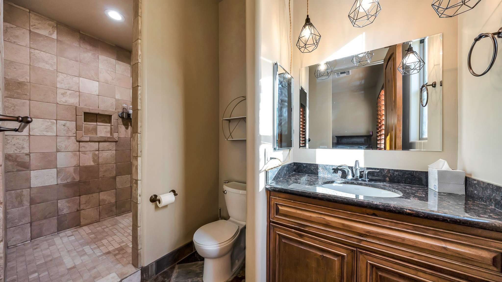 33 of 39. This stylish bathroom includes updated tilework, modern lighting, and a spacious walk-in shower ideal for guests or private living quarters within the casita.