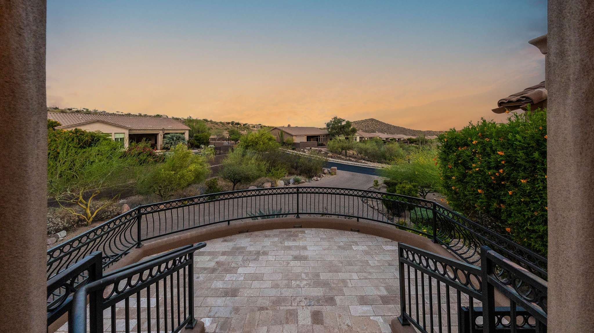 38 of 39. From the elevated front patio, enjoy uninterrupted views of the surrounding Scottsdale landscape and neighborhood. This stone-tiled overlook is ideal for soaking in the desert's golden hour and appreciating the property s peaceful, private setting.